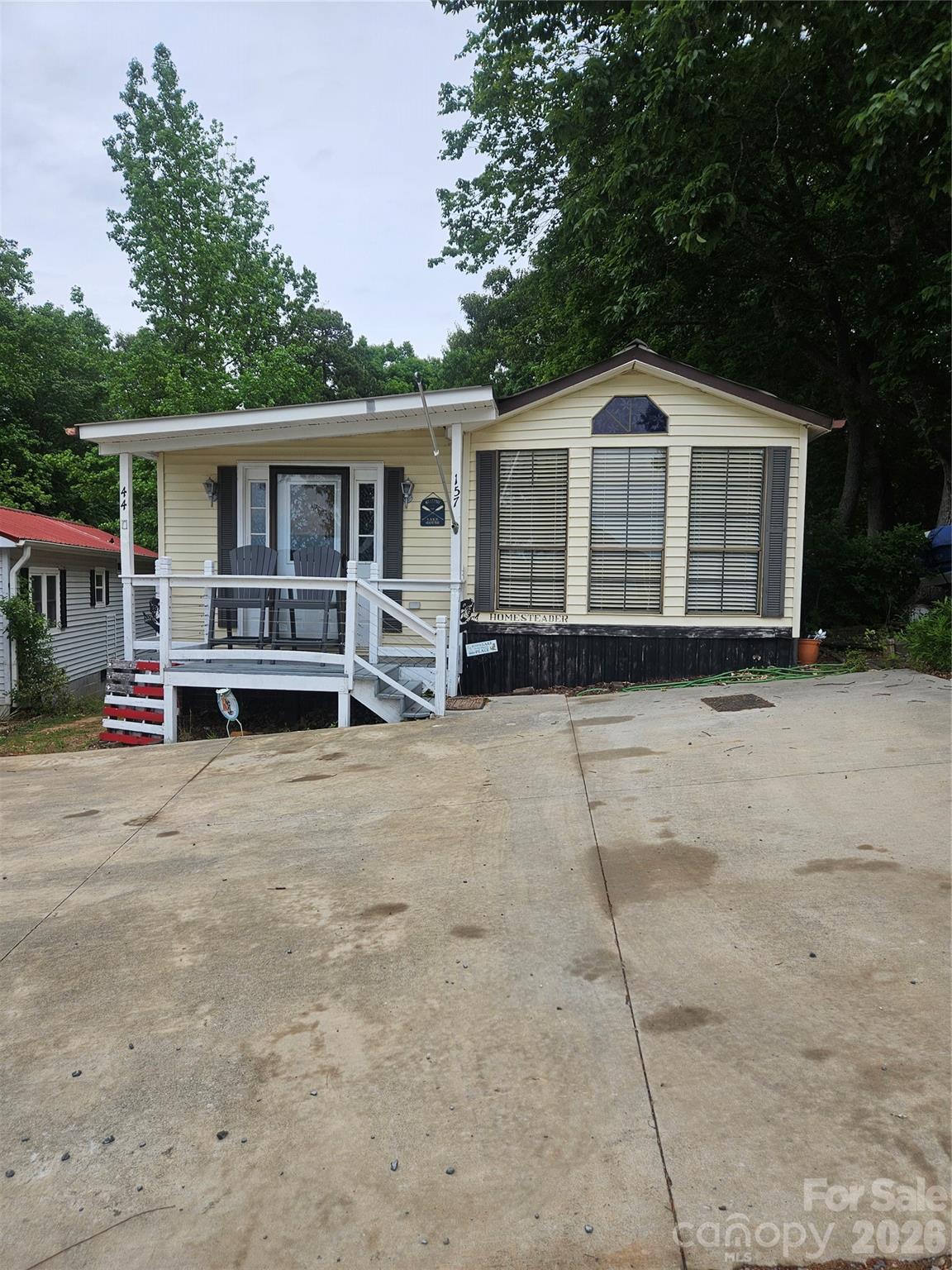 Just in time for Summer, lake life is calling. WATER VIEWS off of your front porch, a swimming pool, club house and your own beach, lakeside.  Come take a look at 157 Dogwood Circle in Badin Shores Resort.  This park model home has *3 bedroom 1 bathroom** Back room added on. You will enjoy a private back yard with a deck, fire pit and building. Fresh paint and Plank flooring. NOT FOR RENT or Owner finance.  Must have agent to enter community/ See HOA disclosures.