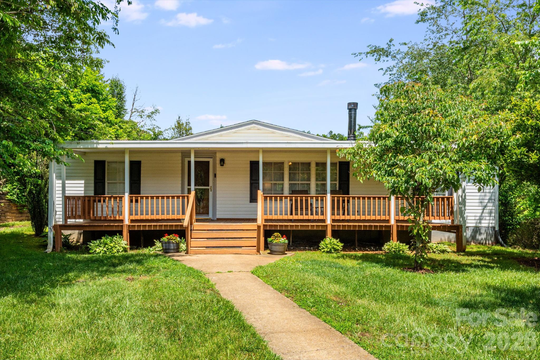 Tucked away at the end of a quiet cul-de-sac, this beautifully maintained home offers exceptional value in a peaceful country setting, complete with paved roads and convenient access to both Weaverville and Asheville. Offering 3 bedrooms and 2 full baths, this inviting home features a recently updated bathroom with a beautiful, tiled shower and a newer roof installed in 2023.

Additional interior highlights include a cozy wood-burning fireplace in the living room, and a desirable split-bedroom floor plan designed for added privacy. On the outside you’ll find a covered carport, a large, wired storage building/workshop, and covered front and rear porches — perfect for relaxing and taking in the mountain views and serene neighborhood surroundings.

A rare find at this price point — don’t miss this move-in ready mountain home!