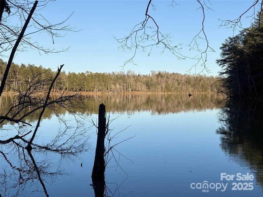 Discover the enchanting allure of a stunning 0.82-acre waterfront property nestled in the coveted “Lake Rhodhiss Estates.”
This exceptional lot boasts a distant view, providing a picturesque backdrop for your future dream home or vacation
retreat. The semi-clear landscape is adorned with beautiful hardwoods, ensuring a private and serene environment, perfect
for launching your canoe or kayak right from your own backyard. Located within a secure gated subdivision, this property is
a haven for lake lovers and outdoor enthusiasts alike. Imagine indulging in scenic boating, fishing, and exhilarating water
sports. Plus, enjoy effortless access to major highways, allowing you to explore the vibrant city of Charlotte, Asheville, and
the breathtaking Blue Ridge Mountains within a short one-hour drive. This rare opportunity is not to be missed. Embrace
the lifestyle you have always dreamed of on the tranquil shores of Lake Rhodhiss.