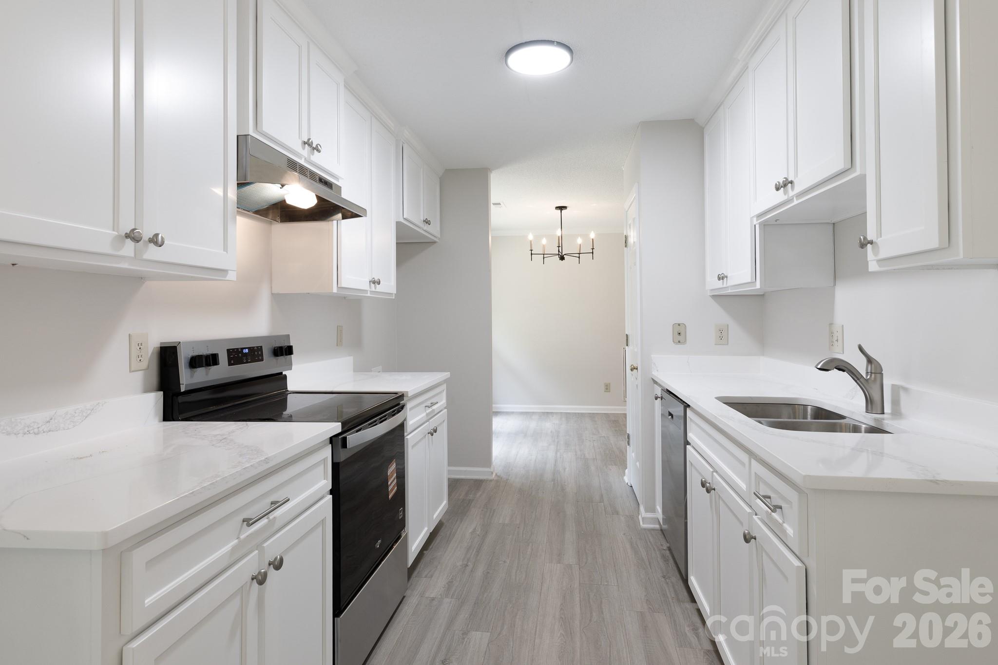 Welcome to this beautifully updated brick ranch in Ravencroft. Designed for effortless modern living, the seamless open floorplan flows naturally from room to room, making everyday life and weekend entertaining feel connected. At the heart of the home is a fully transformed kitchen, completely updated with fresh cabinetry, sleek quartz countertops, new appliances, and a convenient walk-in pantry. The smart split-bedroom layout offers a private retreat for the primary suite, separate from the secondary bedrooms. Inside, the home feels entirely brand new, thanks to a crisp coat of paint, new luxury vinyl plank and carpet, and tastefully updated bathroom cabinets and mirrors. Double dining options with both a formal dining room and a casual dining area provide flexibility for any occasion. Outside, your private, fully fenced backyard awaits, featuring a covered rear patio perfect for relaxing evenings. Complete with an oversized attached garage with an extra storage room and utility sink, and located just moments from local shopping and dining.