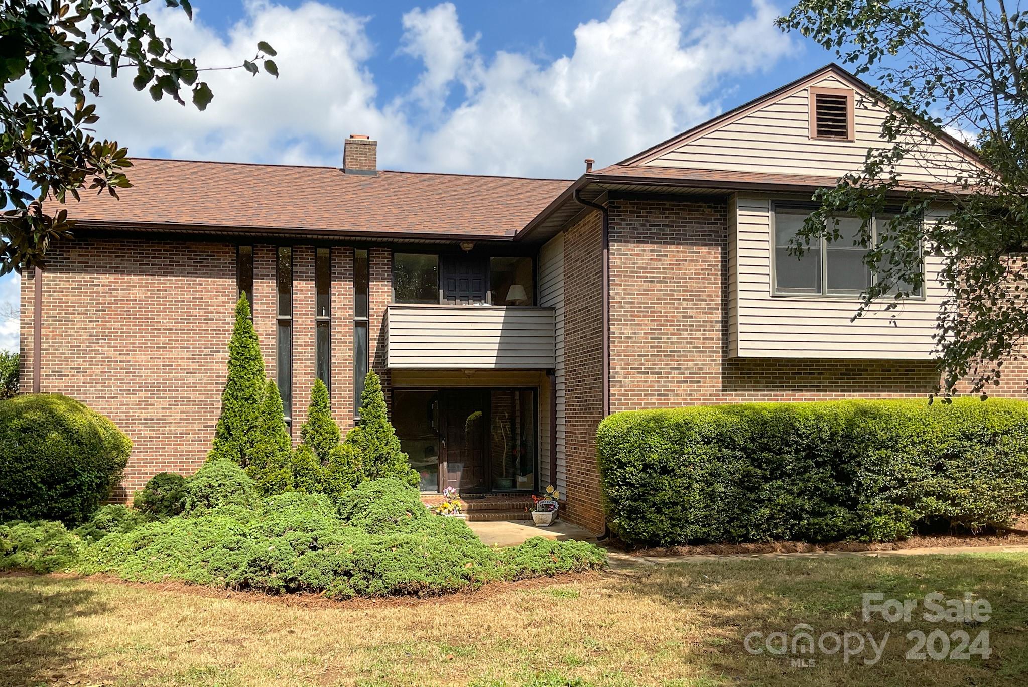 Welcome to 4220 Honeysuckle Drive, a hidden gem on the stunning Sunset Point of Lake Wylie, Rock Hill, SC. Imagine yourself waking up to breathtaking views of the lake, with serene sunrises and captivating sunsets gracing your days from every angle. Nestled on a generous 1.23-acre lot, this unique property boasts expansive lake views in three directions, offering an unparalleled experience of lakeside living on the main part of Lake Wylie.
Step inside this custom-built 1975 estate and envision the possibilities. The home features 3 spacious bedrooms, each with ensuite full bathrooms, providing privacy and comfort for every family member or guest. The sunken den invites you to relax with its cozy gas log brick fireplace and built-in bar, perfect for intimate gatherings or unwinding after a day on the lake. The dining room, complete with a wood-burning brick fireplace, sets the scene for memorable meals with loved ones. The open staircase leads you to a charming garden center.