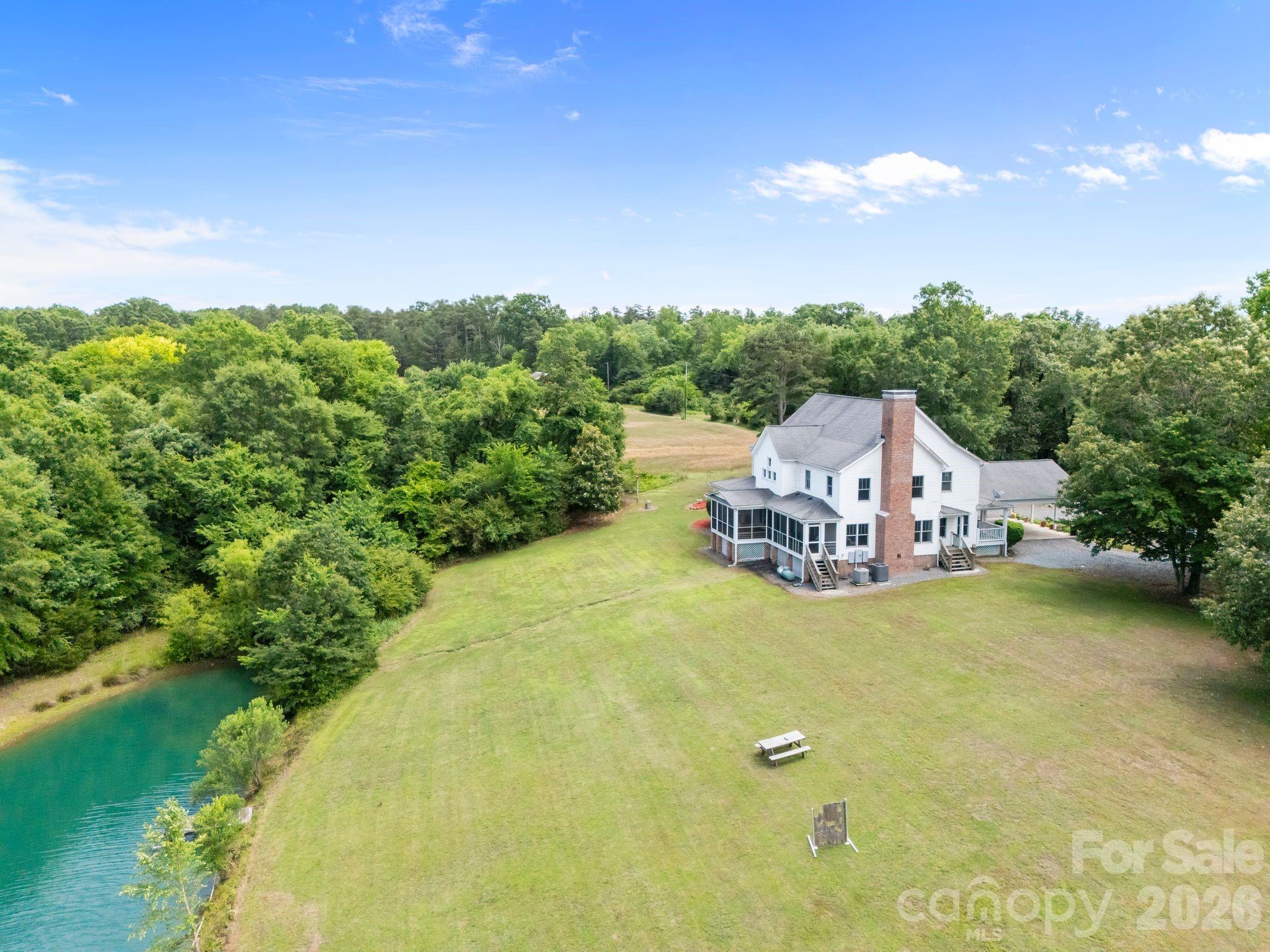 A truly rare opportunity to own a custom-built farmhouse on 10 private acres complete with a fully stocked pond, wooded trails, and a detached barn with plenty of space for hobbies, equipment, and yes... all those Facebook Marketplace purchases you swore you needed.

Picture yourself pulling down the long driveway after a busy day, leaving the noise of the world behind. The kids are fishing by the fully stocked pond, the dogs are exploring the wooded trails, and dinner is waiting on the screened porch as the sun sets across the water.

Properties like this don't come along often. It's more than a home—it's the kind of place where family traditions begin, stories are made, and years from now you'll still remember the day you first drove up the driveway and knew this was the one.

If you've been searching for space, privacy, and a place where memories are made, this may be the one you've been waiting for.

Only 12 minutes from downtown Monroe, 2 minutes from 74 bypass, and ladies less than 20 minutes from Target, dining, shopping and everyday essentials. You must see this in person
