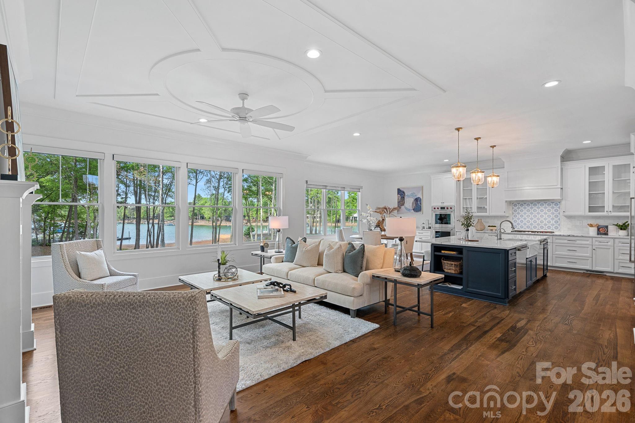 Welcome to your private lakeside retreat in The Point, situated on approximately 170 feet of Lake Norman shoreline. Built in 2024, this exceptional estate offers a newer build rarely seen in The Point, blending timeless Cape Cod style with today's most sought-after finishes and delivering the full Lake Norman lifestyle without compromise. The home is bathed in natural light and offers stunning water views from virtually every level, while the HOA-owned lot bordering the property provides an added layer of privacy rarely found this close to the water. The chef's kitchen features Wolf, Sub-Zero, and dual Cove dishwashers, complemented by craftsman moldings and custom built-ins throughout. The main-level primary suite offers peaceful water views and a custom walk-in closet complete with a washer/dryer hookup for effortless main-floor convenience. Upstairs, three spacious bedrooms surround an open loft with custom built-ins, equally suited as a refined workspace or quiet reading retreat, plus a versatile flex room and private guest suite with en-suite bath. The fully finished lower level delivers a dedicated office with built-ins, en-suite bedroom, expansive family room, exercise space, a full bath with direct pool access for effortless indoor-outdoor lake days, and a laundry room with built-ins and chutes from both upper floors, giving buyers flexible laundry options on both the main floor and basement. Abundant walk-in storage can be found throughout the home. Outside, a saltwater pool and spa overlook the lake, and your deeded boat slip at Pier M #10 is just steps away with dedicated parking, plus private waterfront access for paddleboarding and kayaking. Come experience the water, the views, and every season from your own private retreat at The Point. Welcome Home