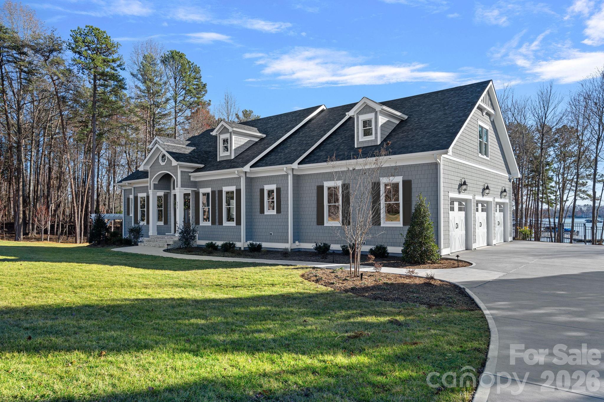 Newly built, move-in ready, and priced for today's buyer. This exceptional 2024 new construction estate in The Point delivers the full Lake Norman lifestyle without compromise Enjoy stunning water views from virtually every level, a chef's kitchen with Wolf, Sub-Zero, and dual Cove dishwashers, and craftsman moldings with custom built-ins throughout. The main-level primary suite offers peaceful water views and a custom walk-in closet. Upstairs, three spacious bedrooms surround an open loft with custom built-ins which is equally suited as a refined workspace or quiet reading retreat; plus a versatile flex room and private guest suite with en-suite bath. The fully finished lower level delivers a dedicated office with built-ins, en-suite bedroom, expansive family room, exercise space, and a laundry room with built-ins and chutes from both upper floors. Abundant walk-in storage throughout. Outside, a saltwater pool and spa overlook the lake. Boat slip Pier M #10 is just steps away with dedicated parking, plus private waterfront access for paddleboarding and kayaking. This is The Point at its finest — move in and start living it.