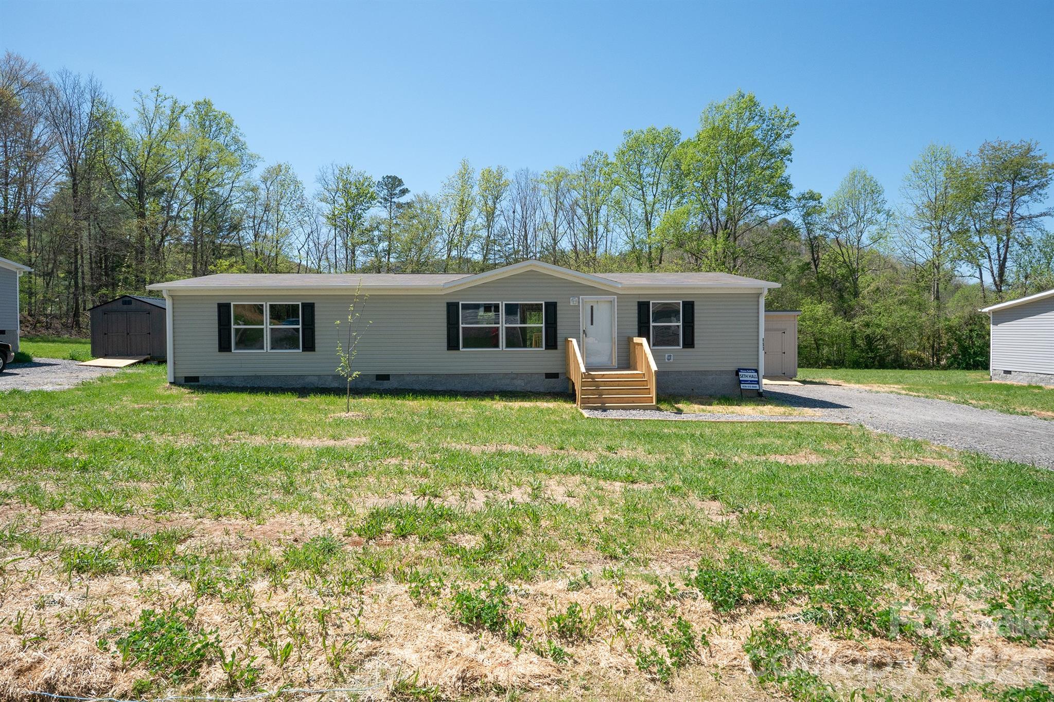 Welcome home to this brand new 2025 Oakwood Homes doublewide, perfectly nestled on a spacious .53-acre lot in the desirable new Peaceful Hill community. Featuring 3 bedrooms and 2 full baths, this thoughtfully designed home offers an open, airy layout with beautiful neutral finishes that make decorating effortless. Wake up and unwind to stunning year-round mountain views from your charming front porch, or enjoy outdoor living on the back deck, perfect for morning coffee or evening relaxation. The property also includes a brand new 8x10 storage shed for added convenience. With a well that has passed water testing and construction meeting FHA standards, this home offers peace of mind and easy financing options. Ideal for first-time buyers, downsizers, or anyone seeking a move-in ready home with modern comfort and serene surroundings, this is mountain living made simple.
