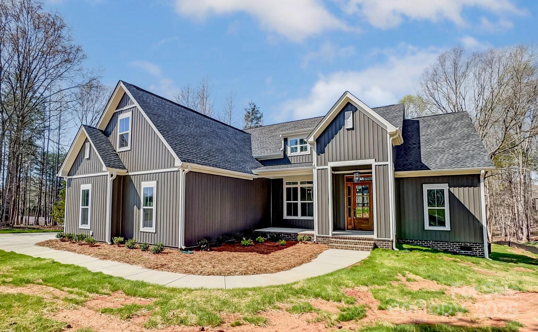 Welcome to 4262 Brandy Creek Ct, a stunning new construction home in the highly sought-after Sanders Landing community! Located in the top-ranked Clover School District, this beautifully designed home offers a spacious split floor plan with an open-concept kitchen and living area. Modern finishes throughout include quartz countertops, a white fireclay farmhouse sink, painted ceilings, and elegant crown molding. The primary suite features dual entrances for seamless access to the laundry room and kitchen, adding a touch of convenience to everyday living. The inviting front entrance sets the tone, while the expansive back porch is perfect for unwinding or entertaining. This is currently the only active listing in the subdivision—a rare opportunity! With low HOA fees and lenient restrictions, this home provides the perfect balance of community and flexibility. Don't miss your chance to own this exceptional home—schedule your tour today!