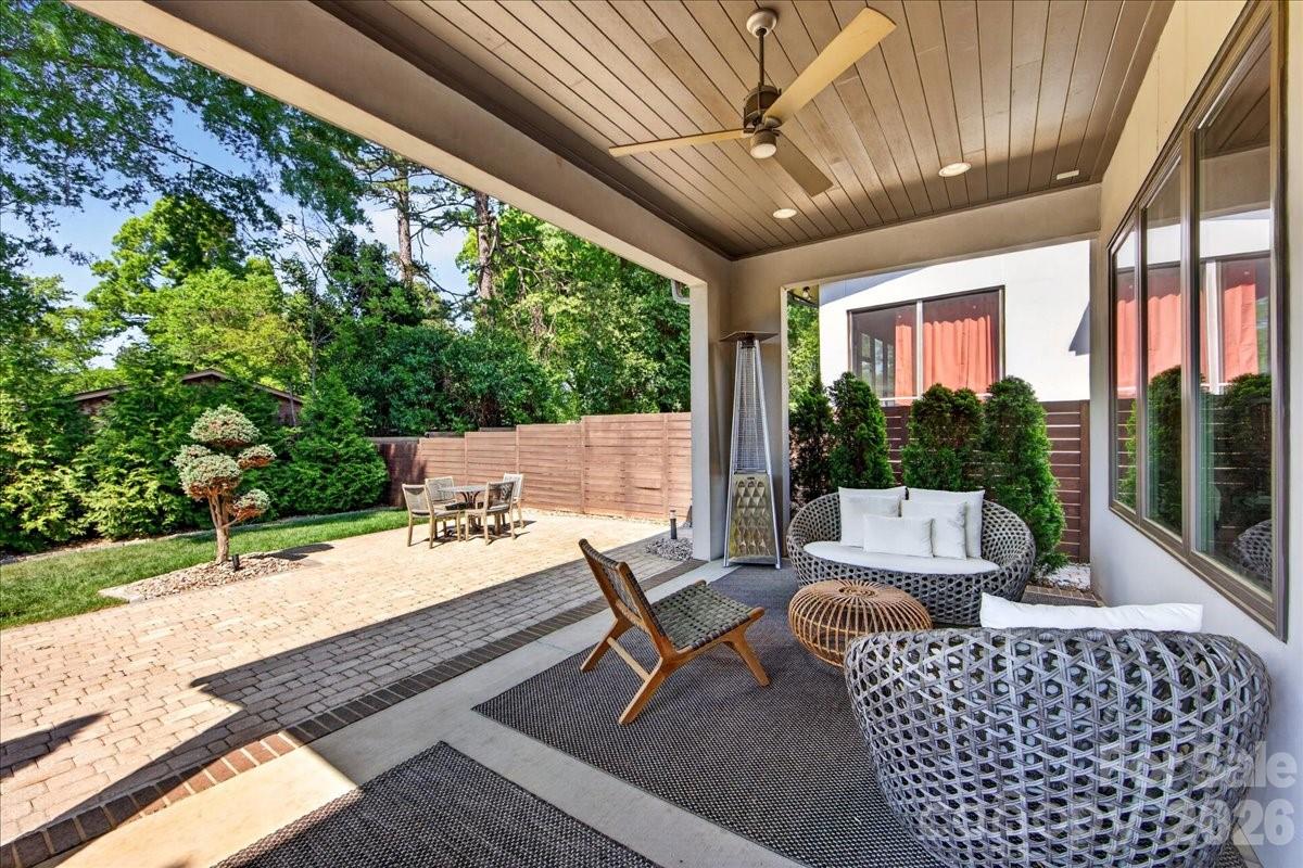 Welcome to this exceptional modern residence, perfectly positioned in the heart of highly sought-after Oakhurst, just minutes from Uptown, SouthPark, and Plaza Midwood, with dining, shopping, fitness, and entertainment at your doorstep.
Designed with sophistication and effortless living in mind, this home makes a striking first impression with a dramatic two-story foyer, a floating staircase, and walls of windows that flood the interior with natural light. Rich hardwood flooring extends throughout, complementing the home's refined contemporary aesthetic.
At the heart of the home, the designer chef’s kitchen is a true showpiece, featuring a stunning quartz waterfall island, premium stainless steel appliances, beverage cooler, and seamless flow into the dining and living spaces—ideal for both intimate gatherings and large-scale entertaining.
The elegant living room is anchored by a custom linear gas fireplace and enhanced by remote-controlled blinds, creating a space that is both inviting and sophisticated. Expansive sliding glass doors open to a covered veranda overlooking the private, fully fenced backyard complete with a paver patio, mature landscaping, and zoned irrigation.
The upper level offers three spacious bedrooms, including a luxurious primary suite designed as a private retreat. Highlights include a custom walk-in closet and a spa-inspired bath featuring dual vanities and an oversized dual-head shower. A well-appointed laundry room with custom cabinetry and sink, along with access to a second-story balcony, adds both convenience and comfort.
Additional luxury features include a two-car garage with epoxy flooring, designer exterior uplighting, and thoughtful upgrades throughout.
A rare opportunity to own a one-of-a-kind contemporary home in one of Charlotte’s most desirable and rapidly growing neighborhoods.