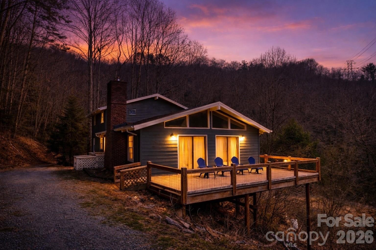 Tucked quietly among the trees and perfectly perched to take in sweeping mountain views, this one-of-a-kind retreat blends privacy, character, and space in all the right ways. Inspired by earthy, tribal design elements, the home offers a warm, grounded feel with expansive, wide-open living areas that invite both relaxation and gathering. This home lives large, featuring an airy layout, abundant natural light, and seamless connection to the surrounding landscape. Major updates have already been taken care of, including a new HVAC system, well upgrades, a refreshed deck, and fresh exterior paint, giving you peace of mind from day one. Whether you’re enjoying the peaceful setting and big views  from the deck or entertaining in the generous interior spaces, this home captures the essence of mountain living in one of the area’s most charming towns.