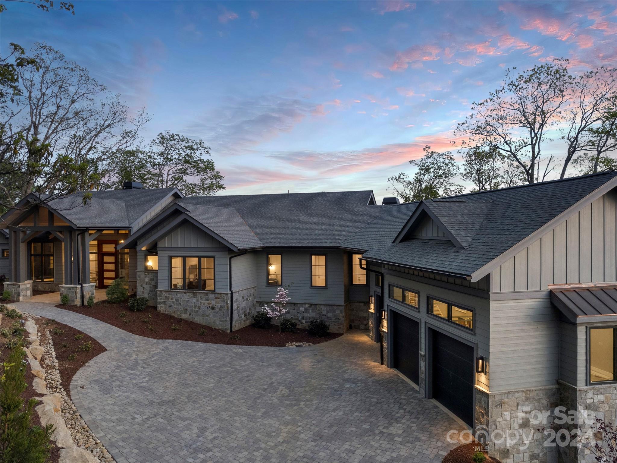 This exquisite contemporary home on almost 4 acres, sits atop the mountain overlooking all of Walnut Cove and the Jack Nicklaus Signature Golf Course! This new construction home encompasses an expansive open floor plan, luxury living, incredible sweeping views from every room; and is the ultimate destination for generations to come together and celebrate in style! Convenient, high-end touches are evident throughout the home. Enjoy main level living with the spacious primary bedroom and splendid en-suite, chef’s kitchen, soaring great room, full guest suite, laundry; as well as an oversized 3 car garage! On the lower level, three well-appointed guest suites, a family room, wine room, and second laundry area await family and friends! This special property borders the National Forest, so your dream home will have the privacy that you desire as well. Come home to Walnut Cove where one membership opens a world of activities and friendships in seven communities in NC and SC!