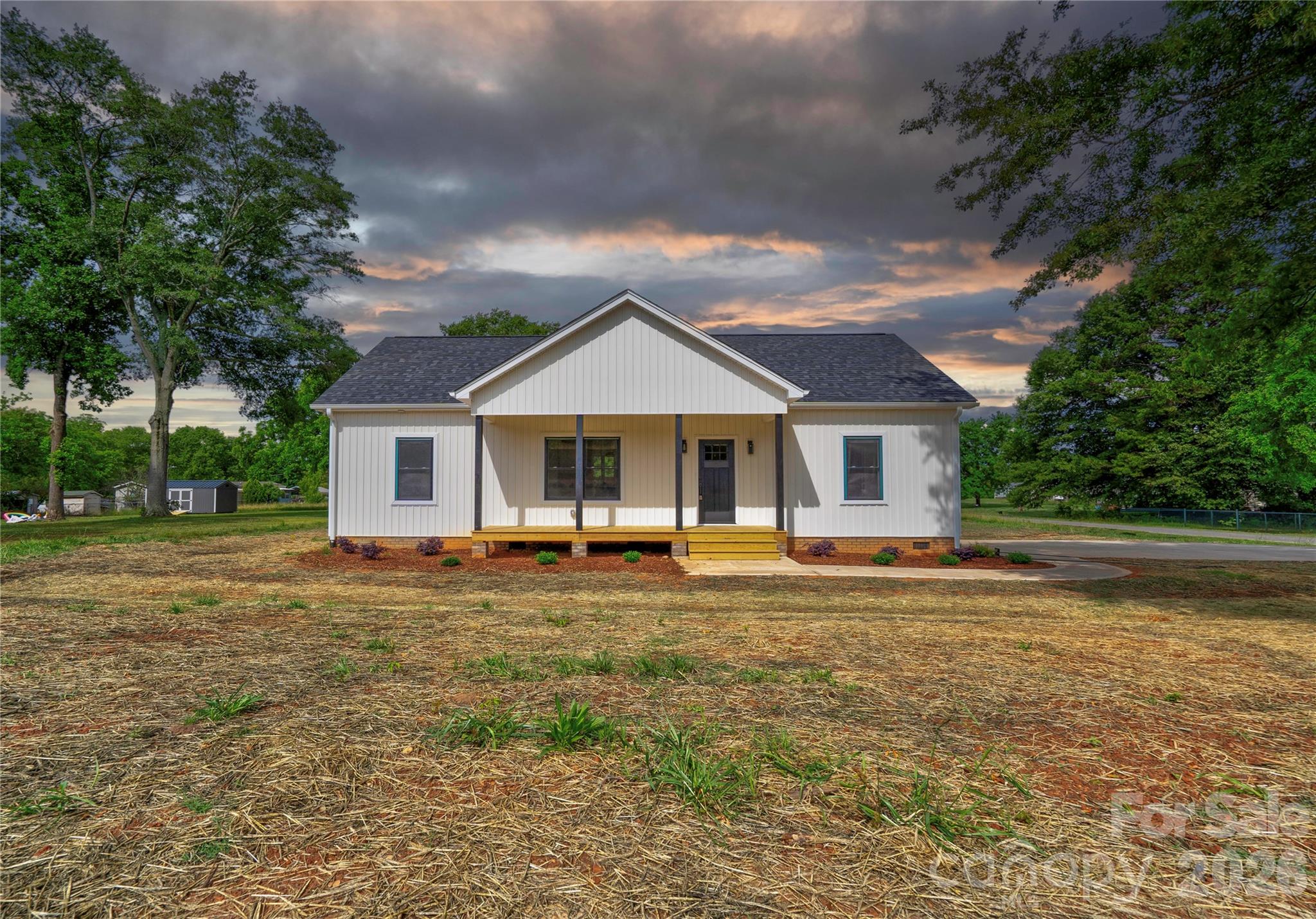 New Construction home! Beautiful and spacious 3 bedroom 2 bath vinyl home on a .61 acre corner lot in a country setting. NO HOA and NO city taxes! Home is situated outside the city limits, but only minutes from town. Home is built with an open floor plan with 9 foot ceilings. Also built with a split bedroom plan for privacy. LVP flooring and neutral colors throughout. Kitchen has quartz countertops, subway tile backsplash, stainless appliances, and a center island with breakfast bar. The dining area has French doors leading to the rear porch. The primary suite features a large walk-in closet, dual vanities, and a large tile walk-in shower. The home has a covered front porch and a large covered rocking chair back porch overlooking the spacious back yard - great places for relaxing! Hurry and schedule your showing while this home is still available!