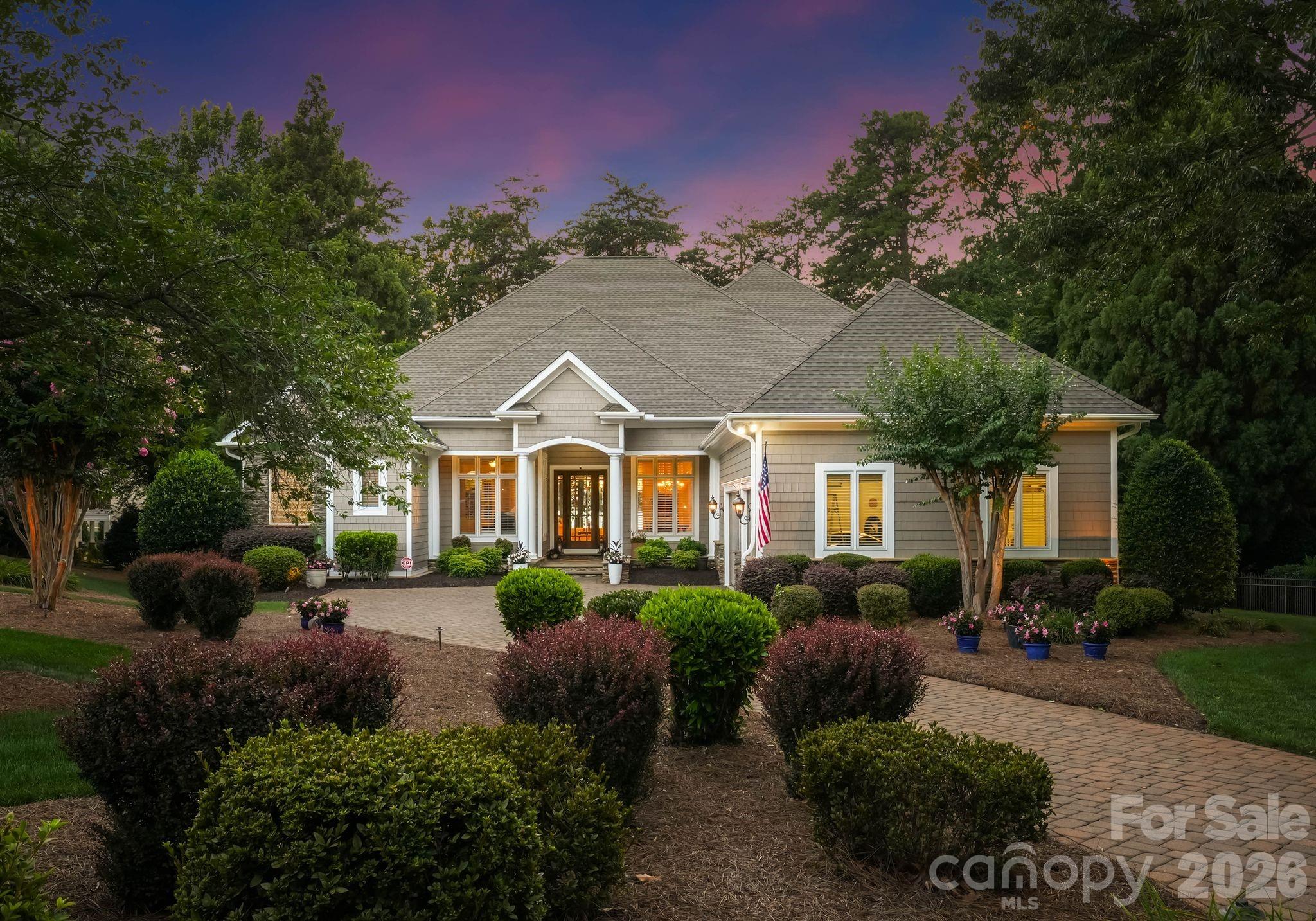 With breathtaking sunset views from nearly every room, this waterfront home makes an unforgettable first impression. Thoughtfully designed for both everyday living and effortless entertaining, the floor plan offers functionality while showcasing the lake at every turn. A dramatic wall of windows welcomes you inside, framing expansive long-range water views. The main-level primary suite is a peaceful retreat, complete with stunning lake views and an expansive en-suite bath. The kitchen flows seamlessly into the breakfast area and great room, where a stacked stone gas fireplace creates a warm gathering space. Also on the main level are a secondary bedroom, a spacious office with French doors and custom built-in shelving, an elegant formal dining room, and a well-appointed laundry room with utility sink. Upstairs, three generously sized bedrooms are centered around a cozy den and a screened porch, the perfect place to unwind while taking in spectacular sunsets. A full-size door provides access to abundant walk-out attic storage. Designed with entertaining in mind, the walk-out lake level features a second kitchen, spacious family room, billiards area, full bath, secondary laundry room, and dedicated fitness space. Outside, the setting is simply exceptional. A covered terrace spans the rear of the main level, complemented by a covered patio below, creating multiple outdoor living spaces to enjoy the tranquil waterfront surroundings. Beautifully maintained landscaping enhances the peaceful setting, while the level backyard offers an ideal opportunity for a future pool. Completing the property, the deeded boat slip is located directly behind the home, making it easy to embrace the Lake Norman lifestyle.