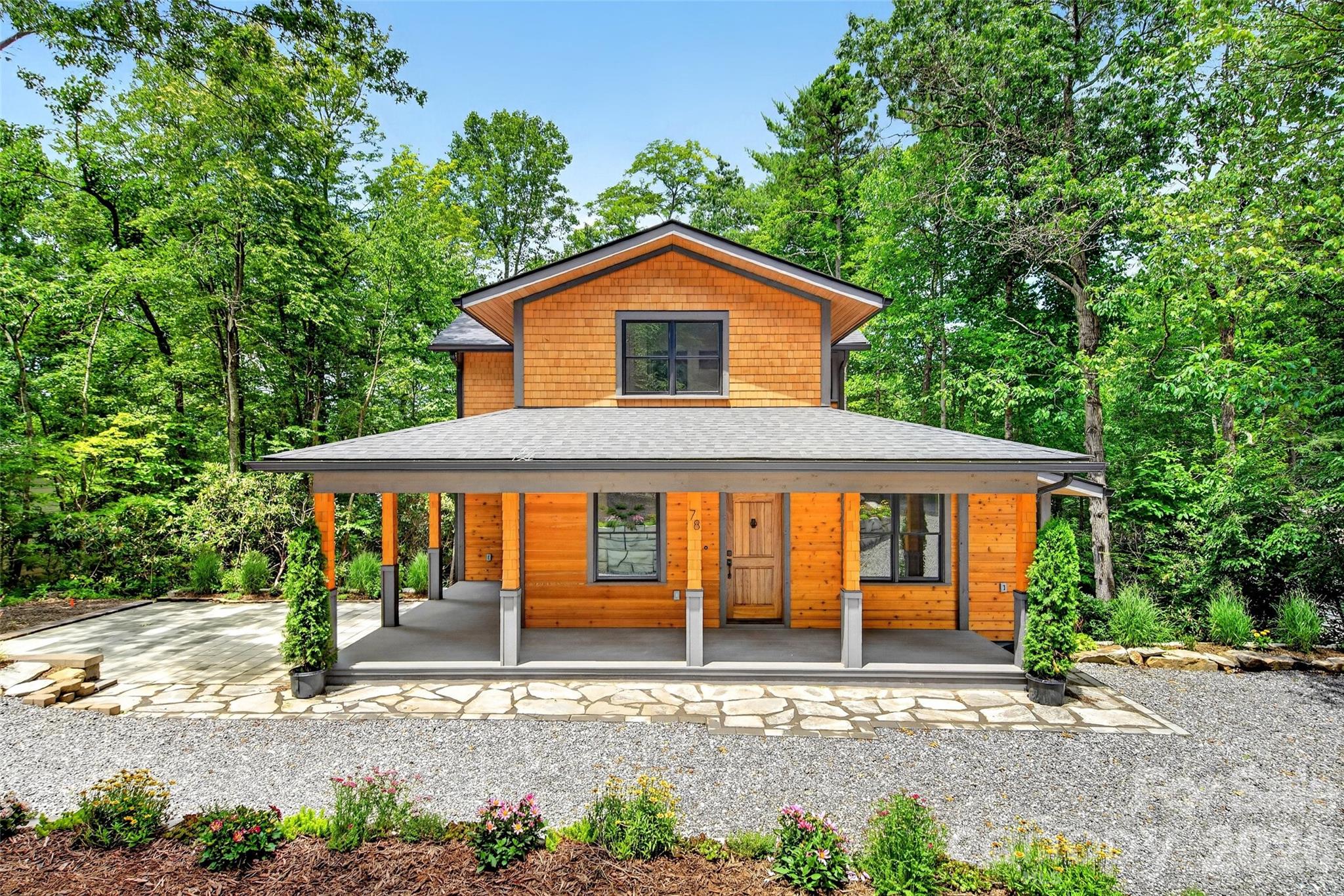 Originally built pre 1900's this charming reconstruction just outside Black Mountain in Ridgecrest has some of the original character. The cedar exterior, gravel circular driveway, covered wraparound porch patio, and back deck create inviting outdoor living spaces. Beautifully landscaped lot. 

The open floor plan features a living room with an electric fireplace, dining area, and well-appointed kitchen with a gas range, refrigerator, dishwasher, and convection oven. The main level also includes a spacious primary suite with a walk-in closet, full bathroom, a half bath, laundry closet, and hardwood and tile flooring throughout.

A spiral staircase leads to the upper level with two bedrooms, a full bath, large windows, and cozy carpeting. Enjoy quality craftsmanship, thoughtful design, and a peaceful setting just minutes from downtown Black Mountain. 

History of the property is attached to the listing details.