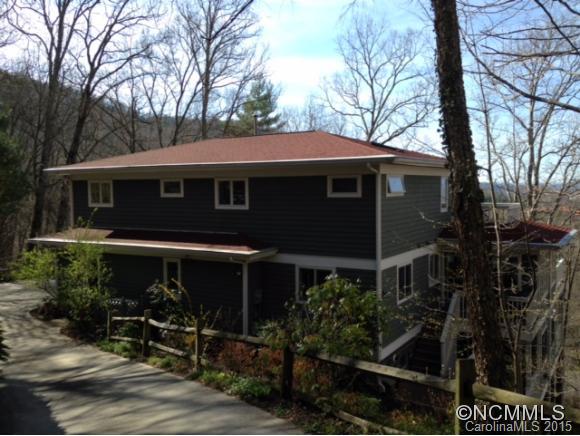 Custom home overlooking the city of Asheville w/views. Open easy living, remodeled spacious kitchen open to dining area & sunroom.3 levels of decking, guest quarters on lower level. Separate Art Studio w/ private deck on lower level.  Master suite has walk-in closet & private study with a deck overlooking the city. Hardwood floors on main level. Large pantry plus mud room going out to double garage w/ storage. Private, 10 min to Asheville
