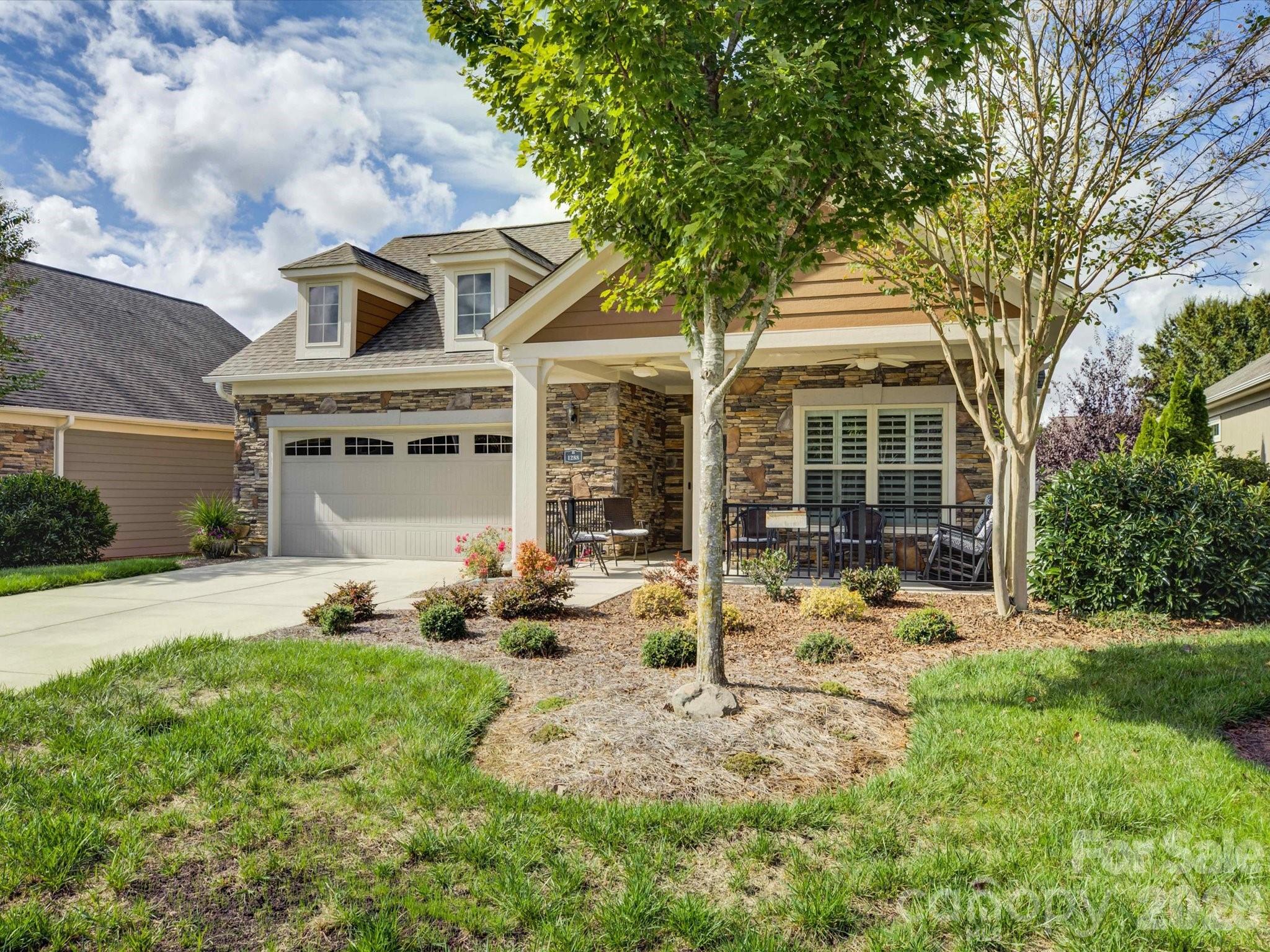 JUST REDUCED!!!   Beautifully appointed 2-bedroom, 2-bath ranch-style home located in The Courtyards of Marvin, one of the Charlotte area’s most prestigious 55+ communities. Manicured landscaping and architectural details create a warm first impression, welcoming you to a residence that blends charm with contemporary design. Step inside and you’re greeted by a bright, open layout where natural light fills the space, highlighting the hardwood floors, recessed lighting, and a custom built-in wall unit that adds both character and functionality. The spacious living room invites you to unwind, entertain, or simply enjoy a quiet evening at home. The gourmet kitchen is a true showpiece—perfectly suited for both casual dining and hosting gatherings. Quartz countertops, stainless steel appliances, custom cabinetry, and a large central island offer a modern aesthetic paired with everyday practicality.  Flexible den or office with French doors just off the living room provides extra space for work or relaxation.  The primary suite offers a private escape designed to feel both luxurious and serene. The generous bedroom easily accommodates a king-sized bed and sitting area. The adjoining ensuite bathroom exudes spa-like tranquility, featuring dual sink vanities with upgraded tile shower.  A spacious walk-in closet provides ample storage and organization, keeping everything conveniently at hand.
The home’s second bedroom offers exceptional flexibility. Whether used as a guest suite, hobby space, or home office, it’s thoughtfully sized to accommodate various lifestyles. Guests will appreciate the easy access to the second full bathroom. Outdoor living is an essential part of the lifestyle at The Courtyards of Marvin, and this home was designed to take full advantage of it. Step through the glass doors from the living area to a covered porch and extended patio, offering the ideal space for morning coffee, casual gatherings,  BONUS.. HOA includes lawn care which means your time is truly your own—no more weekends spent mowing, mulching, or pruning.
Life at The Courtyards of Marvin is all about balance—luxury without hassle, independence with community, and activity without stress.