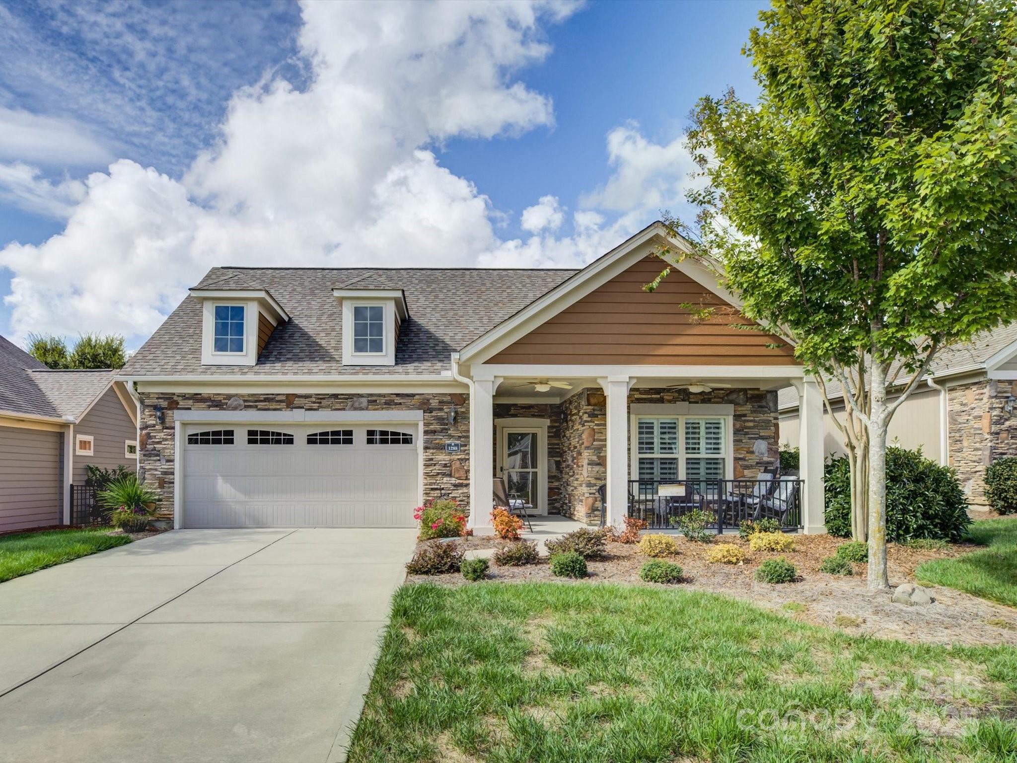 JUST REDUCED!!!   Beautifully appointed 2-bedroom, 2-bath ranch-style home located in The Courtyards of Marvin, one of the Charlotte area’s most prestigious 55+ communities. Manicured landscaping and architectural details create a warm first impression, welcoming you to a residence that blends charm with contemporary design. Step inside and you’re greeted by a bright, open layout where natural light fills the space, highlighting the hardwood floors, recessed lighting, and a custom built-in wall unit that adds both character and functionality. The spacious living room invites you to unwind, entertain, or simply enjoy a quiet evening at home. The gourmet kitchen is a true showpiece—perfectly suited for both casual dining and hosting gatherings. Quartz countertops, stainless steel appliances, custom cabinetry, and a large central island offer a modern aesthetic paired with everyday practicality.  Flexible den or office with French doors just off the living room provides extra space for work or relaxation.  The primary suite offers a private escape designed to feel both luxurious and serene. The generous bedroom easily accommodates a king-sized bed and sitting area. The adjoining ensuite bathroom exudes spa-like tranquility, featuring dual sink vanities with upgraded tile shower.  A spacious walk-in closet provides ample storage and organization, keeping everything conveniently at hand.
The home’s second bedroom offers exceptional flexibility. Whether used as a guest suite, hobby space, or home office, it’s thoughtfully sized to accommodate various lifestyles. Guests will appreciate the easy access to the second full bathroom. Outdoor living is an essential part of the lifestyle at The Courtyards of Marvin, and this home was designed to take full advantage of it. Step through the glass doors from the living area to a covered porch and extended patio, offering the ideal space for morning coffee, casual gatherings,  BONUS.. HOA includes lawn care which means your time is truly your own—no more weekends spent mowing, mulching, or pruning.
Life at The Courtyards of Marvin is all about balance—luxury without hassle, independence with community, and activity without stress.