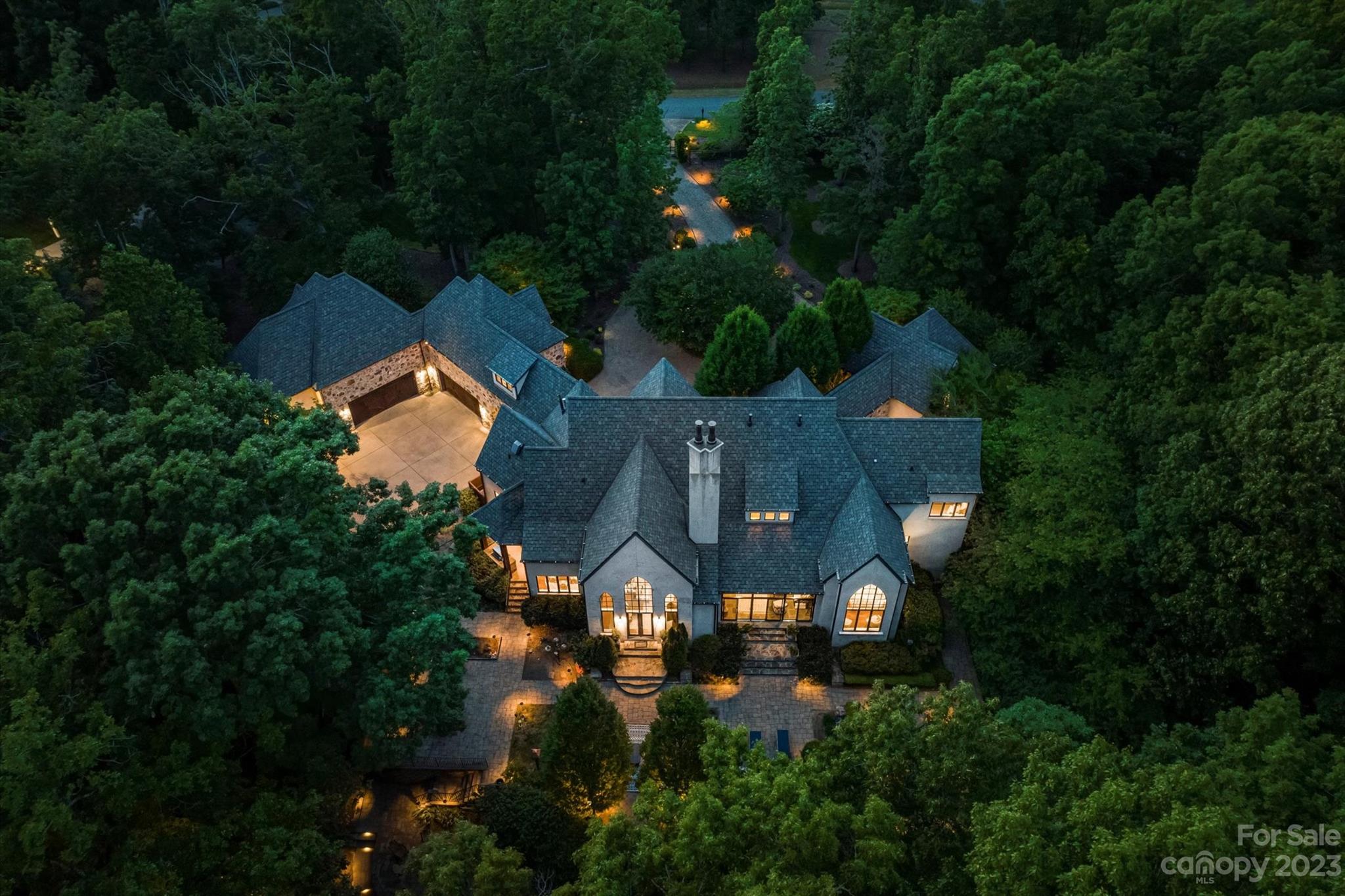 "Nothing To Wine About" ~ This gated English countryside manor is nestled on over 6 wooded acres in The Sanctuary. Old world details & the craftsmanship of custom home builder, Arcadia. Home overlooks traditional English gardens backed by wooded landscape creating spectacular views. Arched ceilings frame the large Gothic windows, creating light filled rooms. Brazilian walnut hardwood floors flow through this home designed for entertaining & comfortable family living. Chef inspired kitchen with Viking appliances, custom island opens to breakfast, great room & formal dining. Main level primary suite overlooking the rose garden. Covered walkway leads to the guest house w/vaulted ceiling, kitchen & full bath. Stunning english gardens out back with stone walkway & babbling brook leading to the absolutely incredible wine cottage like no other holding 1700 bottles of your favorite wine! Enjoy outdoor living in total privacy w/ in-ground fire pit & so much more on this 6 acre wooded sanctuary!