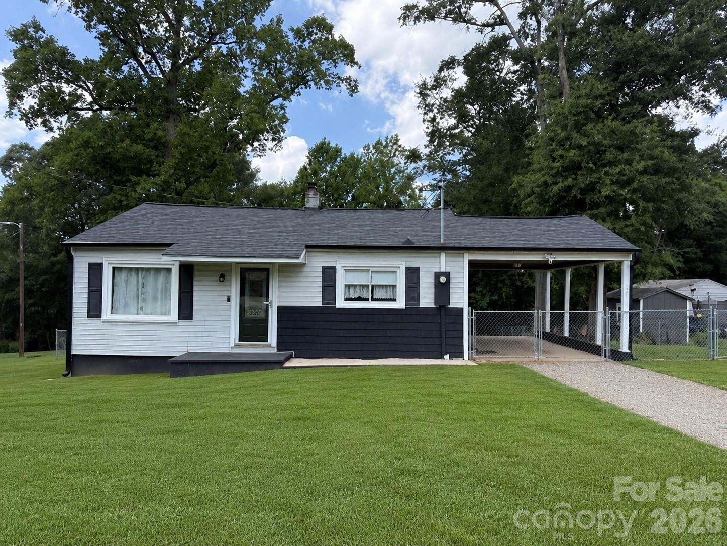 Adorable and beautifully maintained home tucked away in the charming town of Stanley! Enjoy peaceful living just outside the city with a large, fenced backyard that's perfect for relaxing, entertaining, or letting pets play. Step inside to find beautifully refinished hardwood floors and a spacious, welcoming living room filled with natural light. The updated eat-in kitchen features bright white cabinetry, stylish countertops, luxury vinyl plank flooring, stainless steel appliances, and plenty of space to gather.  The generously sized bedrooms offer ample closet space, while the completely renovated bathroom boasts a new vanity, updated fixtures, new flooring, and a beautifully refreshed tub. Fresh paint throughout gives the entire home a clean, move-in-ready feel. Outside, the attached carport doubles as a great covered entertaining space, and the large, updated deck is perfect for grilling, hosting friends, or enjoying quiet evenings outdoors. Additional updates include the roof, windows, well pump, and septic tank, providing added peace of mind. This home is truly move-in ready and waiting for its next owner!