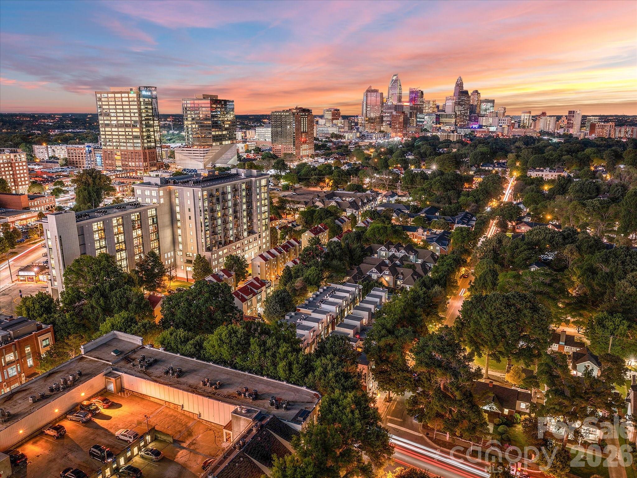 Welcome to Lofts Dilworth, a contemporary condo complex located in the heart of Dilworth and just minutes to Southend! Enjoy the wonderful walkability to some of Dilworth's best restaurants or enjoy the ease of shopping at the Atherton Mill in Southend. This 2 bedroom 2 full bath END UNIT condo has a RARE oversized rooftop terrace that has beautiful views of Uptown Charlotte & the Southend skyline! The lower level features features an attractive primary suite with two closets, one being a walk-in.  The primary bath features dual vanities, a walk-in shower and the convenience of a stackable washer & dryer which convey with the condo.  The main level features a sleek and modern kitchen that is open to the main living room and breakfast nook and then a second bedroom that is currently staged as an office. Also on the main level is another full bath with a walk-in shower.  Enjoy the lovely exterior views from every level out the floor to ceiling windows that flood the property with natural light. This condo has been freshly painted throughout. The windows have treatments/shades that will convey. This condo comes with two unassigned covered parking spots. Do not miss this beautiful condo in an unbeatable walkable location to all that Dilworth and Southend has to offer!