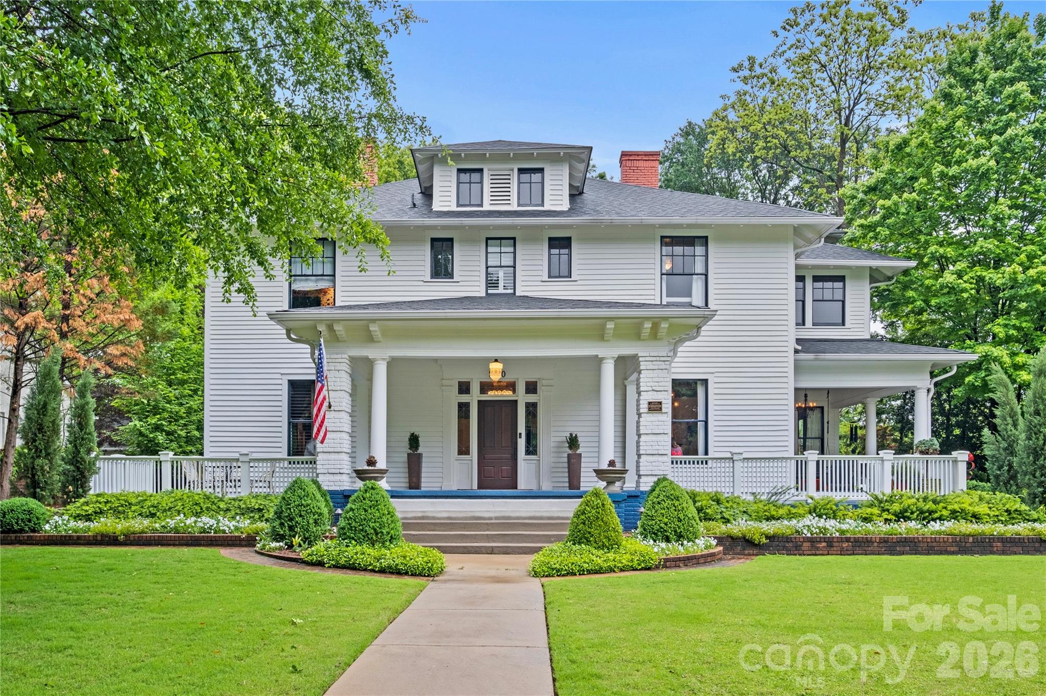 A rare opportunity to own one of Charlotte's most significant historic residences, the Bishop John C. Kilgo House is a distinguished architectural landmark prominently sited along The Plaza in the heart of Plaza Midwood. Designed by renowned architect Louis H. Asbury and completed in 1915 as the residence of Bishop John C. Kilgo, former president of Trinity College (now Duke University), the home beautifully blends Colonial Revival elegance with Craftsman influences, creating a residence of exceptional character and enduring appeal.

Thoroughly updated throughout, the home masterfully marries contemporary design with historic integrity. Thoughtful renovations preserve the craftsmanship, proportions, and architectural details that define the property while introducing modern finishes, systems, and amenities that complement today's lifestyle. The result is a home that feels both timeless and remarkably livable.

Grand yet welcoming, the residence offers beautifully proportioned living spaces, abundant natural light, and an effortless flow for both everyday living and entertaining. Original architectural details—including rich millwork, gracious staircases, expansive windows, and period fireplaces—have been carefully preserved, while every update has been executed with a respect for the home's remarkable history.

Set on a prominent corner lot with mature landscaping, this iconic residence offers a rare chance to become the next steward of one of Charlotte's treasured historic homes—where more than a century of history meets sophisticated modern living.