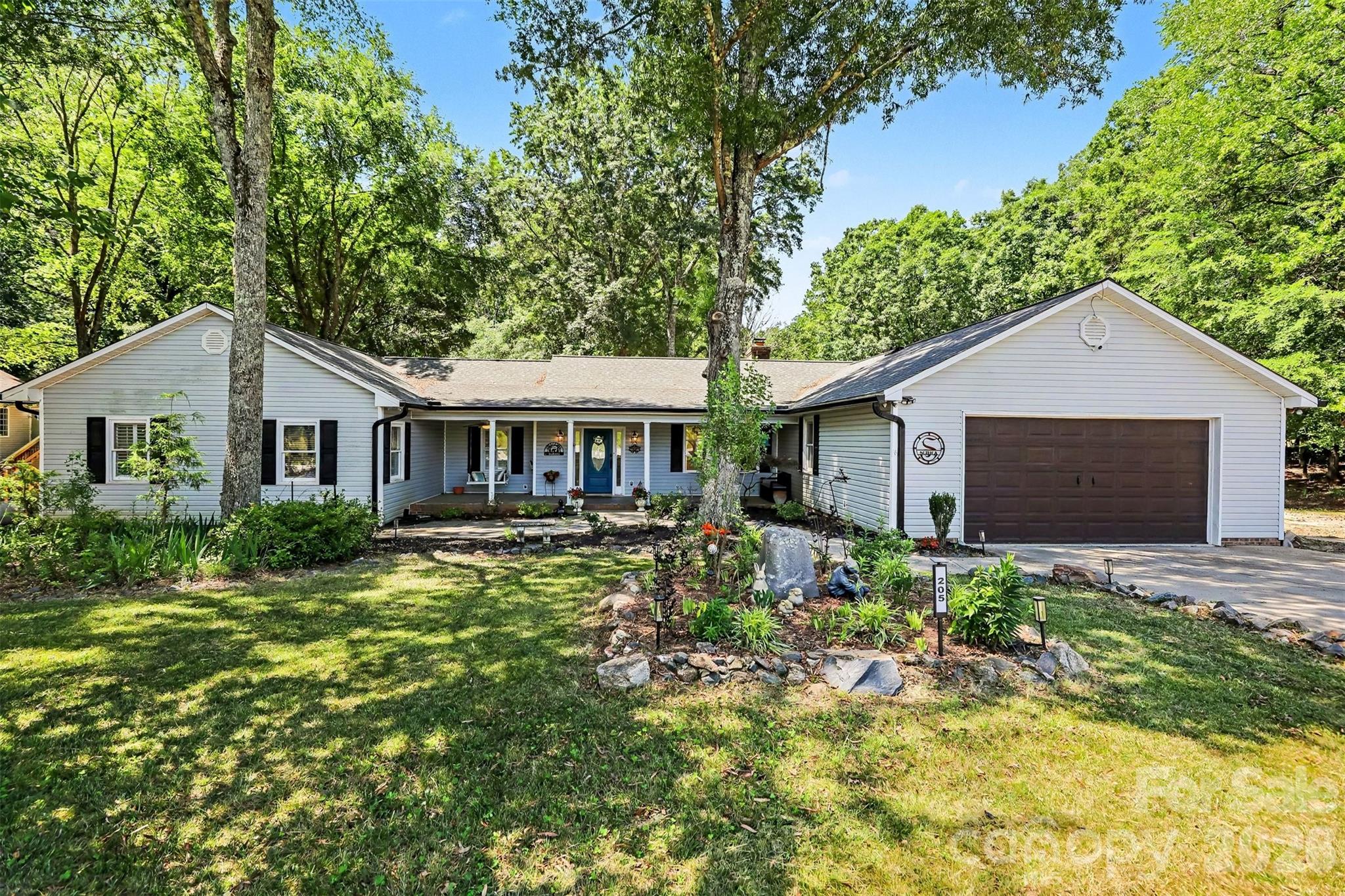 NO HOA! OVER 3 ACRE PRIVATE OASIS IN THE HEART OF WEDDINGTON! If ultimate freedom, unparalleled privacy, and sprawling acreage are at the top of your wish list, welcome home to 205 Dornoch Drive. Tucked away at the end of a quiet, private road in one of the region’s most highly desirable areas, this property offers a rare combination of country-like serenity and suburban convenience. Situated on a magnificent 3.34-acre wooded parcel within the award-winning Weddington School District, this estate provides a peaceful sanctuary just minutes from Waverly, Rea Farms, and I-485, giving you seamless access to premier shopping, fine dining, and city conveniences while maintaining total seclusion.

With absolutely no homeowner association restrictions, this massive acreage is a blank canvas awaiting your vision. The property offers incredible, unlimited potential for a variety of lifestyles. It is a dream setup for homesteading, allowing you to establish a hobby farm, plant expansive gardens, or raise chickens in a private, unrestricted environment. Investors and builders will appreciate the potential for subdividing the gorgeous acreage, while others may choose to expand the existing home, build a secondary guest house, or create a multi-generational family estate.

The charming, true ranch-style residence features 2,384 square feet of comfortable, single-level living. Inside, you are greeted by spacious living areas with an exceptional, easy flow designed for both everyday relaxation and large-scale entertaining. The heart of the home centers around a cozy fireplace, adding warmth and timeless character to the main living space. The large kitchen and family areas flow naturally toward the rear of the home, framing views of your outdoor paradise.

Step outside into a brand new, custom deck that serves as the ultimate launchpad to a backyard oasis that feels worlds away from the hustle and bustle. Surrounded by a majestic canopy of mature trees, your private retreat features a sparkling in-ground pool designed for endless summer fun. The outdoor entertainment spaces are truly unmatched, boasting a custom bocce ball court for weekend games, a beautiful serenity pond (currently being finished) that adds soothing natural ambiance, and a lively tiki bar area that makes every day feel like a vacation. It is the ultimate setup for summer cookouts, pool parties, or quiet evenings listening to the sounds of nature.

Another standout crown jewel of this property is the massive, 913-square-foot detached wired workshop. Perfectly suited for artisans, woodworkers, car enthusiasts, or hobbyists, this space offers incredible utility. Even better, it includes a finished second-floor office space, providing the perfect separation for a quiet home business, creative studio, remote workspace, or extensive extra storage.

Properties of this scale, featuring this level of privacy, unmatched outdoor amenities, and development flexibility—all without the constraints of an HOA and located in a top-rated school zone—are exceptionally rare. Whether you are looking for a private family compound, a homesteader’s paradise, or a secure long-term investment, 205 Dornoch Drive delivers a lifestyle of freedom you simply cannot find in a traditional subdivision. Schedule your private tour today and experience the endless possibilities for yourself!