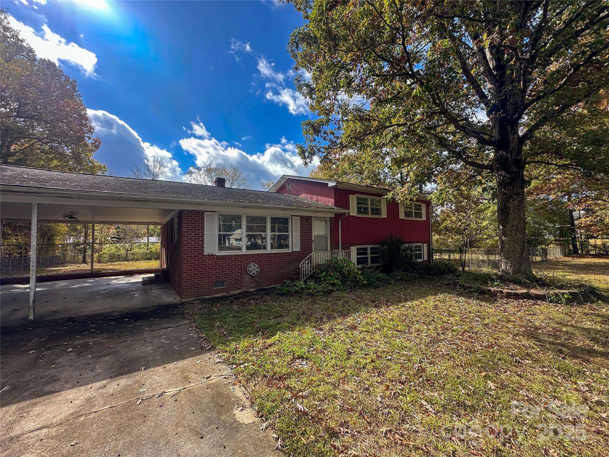 This 1965 split-level home offers a convenient location just east of Albemarle, close to the 24/27 bypass, with a quiet setting on a non-paved street. The property includes 3 bedrooms and 2.5 baths, a partially finished lower level, and a large fenced yard. The layout provides potential for functional separation of living and storage areas.
A patio door off the primary suite leads to a back deck that will need to be rebuilt, and the home overall will require significant repairs and updates throughout. This is a great opportunity for an investor or homeowner looking for a project in a convenient area. Being sold as-is, seller will make no repairs.