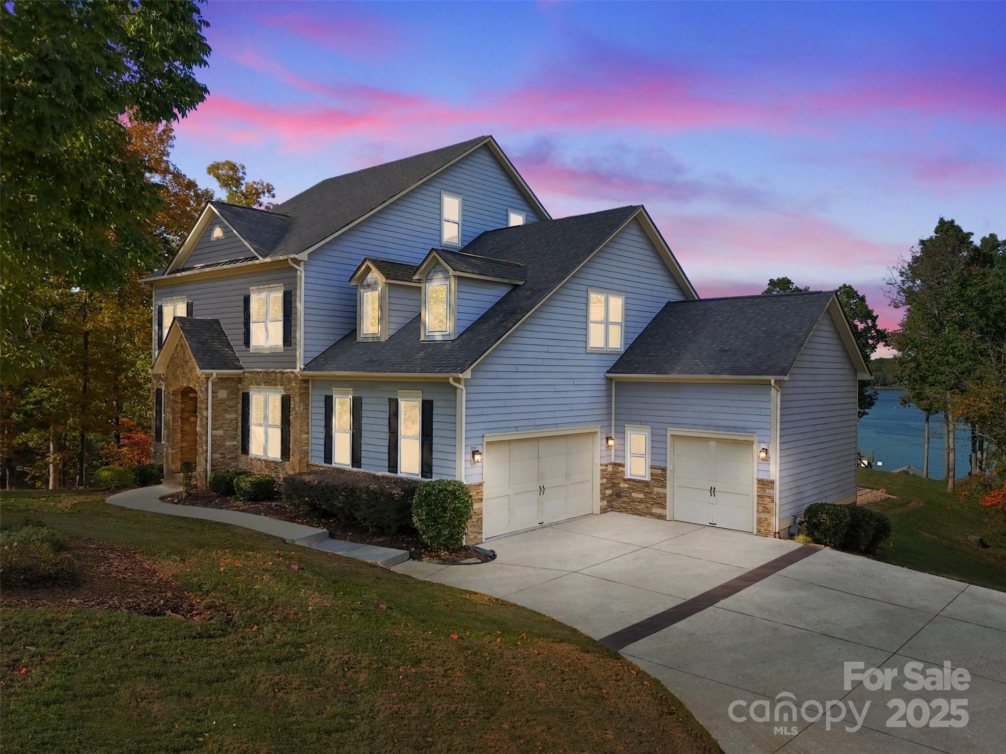 Discover the ultimate in LAKEFRONT LUXURY! Stunning 2.5-story estate perfectly situated on a private peninsula lot with deep-water access and breathtaking panoramic views of Lake Wylie. With over 5,200 square feet of meticulously designed living space, this custom residence blends timeless elegance, functionality, and modern upgrades for an unparalleled lakeside lifestyle.

Grand open-concept layout filled with soaring ceilings, expansive windows, and an abundance of natural light showcasing the serene water views from nearly every room. Residential elevator gives easy access to pool on ground level, 1st floor & 2nd floor. Gourmet kitchen features an oversized island, gas cooktop, walk-in pantry, and seamless flow to the great room and breakfast area—perfect for entertaining or casual family gatherings.

Primary suite on the main level offers sweeping lake views and a spa-like bath with dual vanities, walk-in shower, soaking tub and two large walk-in closets. Upstairs, you'll find three additional bedrooms, a bed/bonus room, and an exercise/office room, offering ample room for family and guests.

The third level is designed for entertainment, featuring a media room, wet bar, and half bath—ideal for movie nights or game-day gatherings.

Step outdoors to your private resort-style oasis: a Pebble Tec pool with tanning ledge and waterfall feature spilling from the hot tub, surrounded by a travertine patio, gas fire pit, and newly added safety fence. Enjoy effortless lake access with your covered dock, boat lift, and a tram system for convenient transport to the shoreline.

Luxury upgrades include a residential elevator, whole-home generator, game room addition, chair lift in the garage; enhancing both comfort and accessibility, 2 new HVAC units (June 2025) and new tankless water heater! (Oct. 2025)

Experience the best of South Carolina living with award-winning schools, low taxes, and deep water year-round—all in a peaceful, private setting.

Your Lake Wylie dream home awaits at 3099 Willow Breeze Lane—where luxury meets lifestyle!
