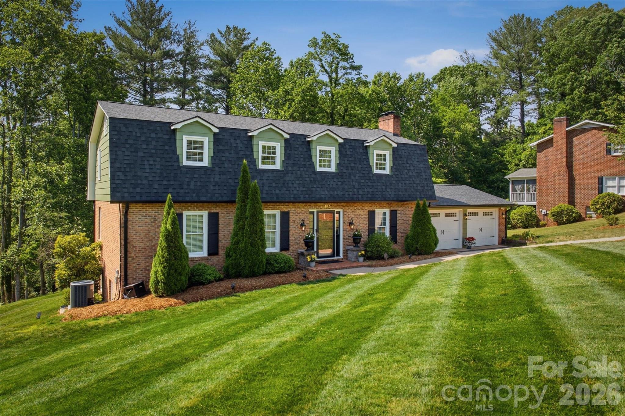 Located in a great neighborhood just minutes from Downtown Morganton, this 4-bedroom home offers a wonderful blend of space, functionality, and timeless charm. Step inside to an elegant first impression featuring a winding staircase that welcomes you into the home.

The updated kitchen showcases beautiful countertops that continue into the backsplash, creating a clean and elevated look. Enjoy both an eat-in kitchen and formal dining room, giving flexibility for everyday living and entertaining alike. Step out onto the large back deck overlooking the private backyard. The spacious living room provides plenty of room to gather, while the cozy den features a fireplace and built-in shelving, making it an ideal second living area, home office, or reading room. A convenient half bath for guests and the laundry room are also located on the main level.

Upstairs, all four bedrooms are thoughtfully situated together, including a well-appointed primary suite featuring dual sinks, a soaking tub, and separate shower. Three additional bedrooms and a full hall bathroom complete this level.

The finished basement features a recreation room complete with a full bathroom, offering endless possibilities for entertaining, hobbies, guests or flex space. From here, step out onto the covered patio tucked beneath the back deck, creating multiple spaces to relax and enjoy the outdoors.

Situated on a generous corner lot, this property offers plenty of room to enjoy outdoor living. The main-level 2-car garage provides everyday convenience, while the additional basement garage is perfect for lawn equipment, workshop space, or extra storage.

From its flexible floor plan to its sought-after location near Downtown Morganton, this home is ready to fit a variety of lifestyles.