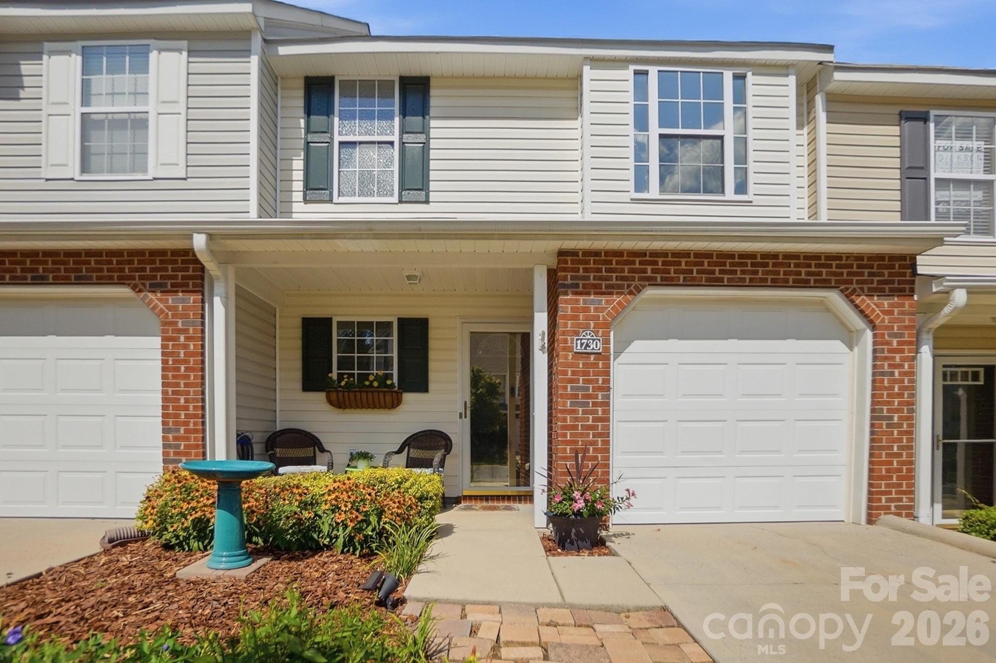 Welcome home to Lexington Commons! This 2 bedroom, 2.5 bath townhome is the LARGEST 2-bedroom floorplan in the community at 1,412 sf which offers more usable space, especially in the bedrooms, than comparable units nearby. Freshly painted with new LVP flooring throughout the main level and both bathrooms, plus new carpet upstairs. HVAC replaced in 2021, and appliances are just 2 years old, including washer, dryer and garage refrigerator, which convey!
Upstairs, both bedrooms feature vaulted ceilings, their own private bathroom, and a walk-in closet, with the front bedroom offering a bonus 2nd closet. Laundry is conveniently located upstairs as well.
The main level offers an open, comfortable layout: a wide foyer with coat closet and half bath leads into a bright living room with fireplace, a kitchen with abundant counter and cabinet space, and a dining area with direct access to the rear patio.
Parking is no issue.  Enjoy a 1-car garage, private driveway, and an additional assigned parking space can be purchased, if available.  
HOA ($205/mo) covers the community pool, lawn care, exterior maintenance, and termite bond... genuinely low-hassle living.  No rental restrictions, except STR (under 30 days) makes this a great option for owner-occupants and investors alike.
Location is a win.  Minutes to I-77 with the Charlotte border about 15 minutes away.  Close to restaurants and grocery stores, and near Riverwalk Carolinas (walking/biking trails, BMX track, velodrome, and river access) as well as Ebenezer Park on Lake Wylie. Don't miss the biggest 2-bedroom value in Lexington Commons!