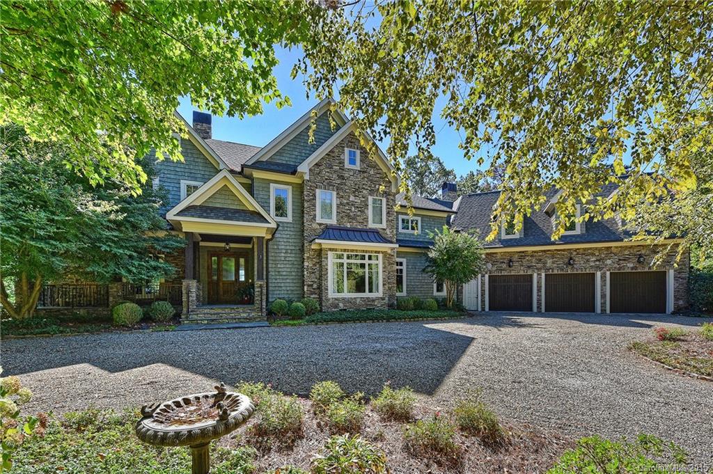 One of Lake Norman's quintessential Nantucket style estates. This classically designed home exudes casual elegance with refined craftsmanship. Gracious flow throughout with open layout for entertaining & spectacular lake views from all rooms. Gourmet kitchen features an expansive wood island & custom iron light fixture as the centerpiece. Owner's retreat has private balcony, morning kitchen, spacious bathroom. Relax lakeside under the covered veranda. Room for a future pool.