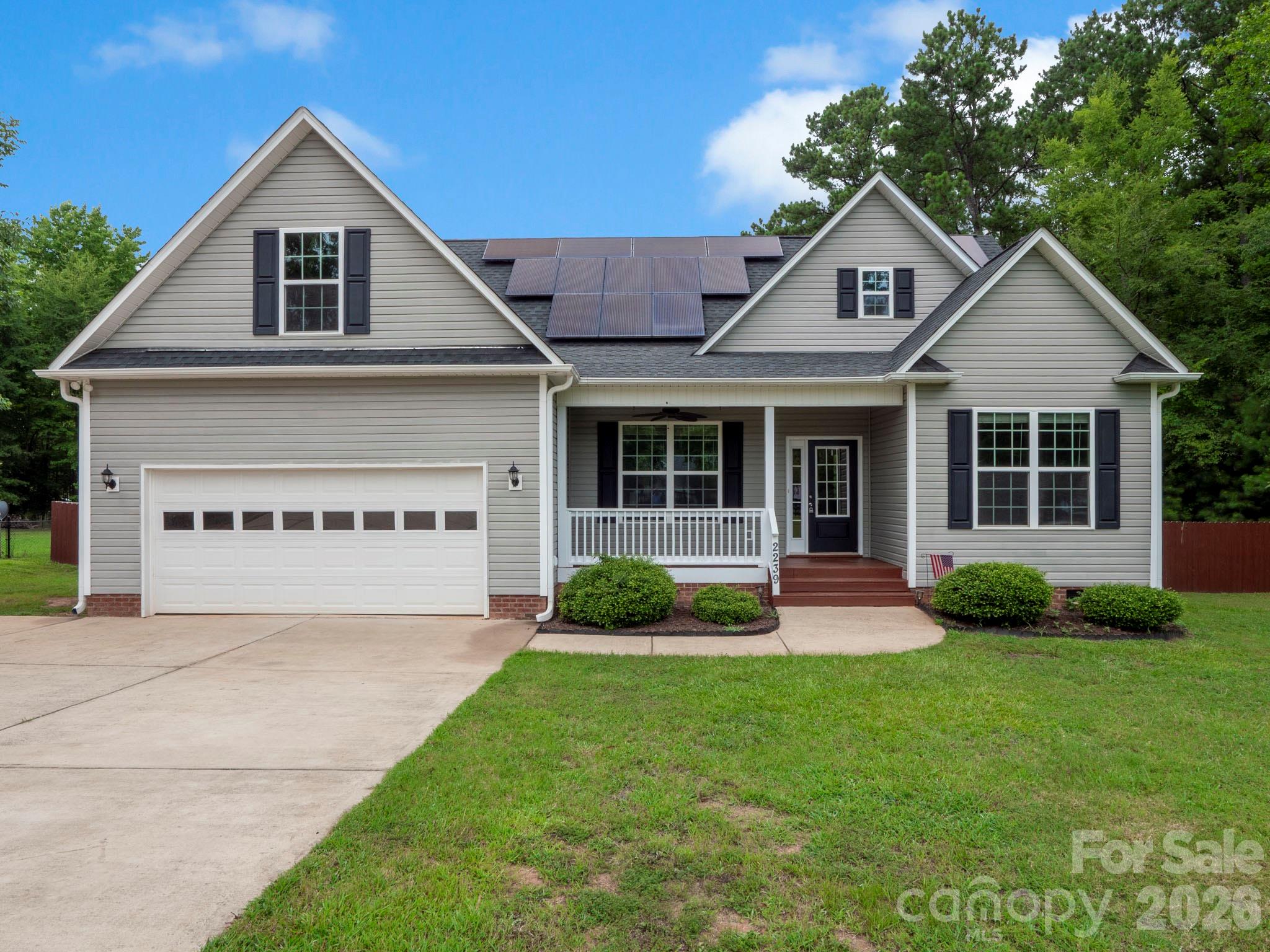 Escape the neighborhood without sacrificing convenience! Nestled on a picturesque 1-acre homesite surrounded by mature trees, this beautifully maintained home offers the privacy and freedom today's buyers are searching for—with NO HOA and an owned solar power system that helps keep monthly utility costs low. Step inside to an inviting open floor plan designed for everyday living and entertaining, featuring a spacious great room, breakfast bar, split-bedroom layout, and abundant natural light. The private primary suite serves as a relaxing retreat with a large walk-in closet, soaking tub, separate shower, and dual vanities. Upstairs, the finished bonus room provides exceptional flexibility for a home office, media room, playroom, guest space, or even a fourth bedroom. Recent improvements—including fresh interior paint, brand-new carpet in all bedrooms, and newly stained front and rear porches—make this home truly move-in ready. Outside, enjoy evenings around the fire pit, relax on the covered front porch, entertain on the back deck, within the fully fenced backyard. With an attached two-car garage, well and septic, modern construction (2018), and a peaceful country setting just minutes from York and Rock Hill, this home offers the perfect combination of comfort, efficiency, and privacy. If you've been dreaming of space to spread out without giving up modern conveniences, this is the one you've been waiting for.