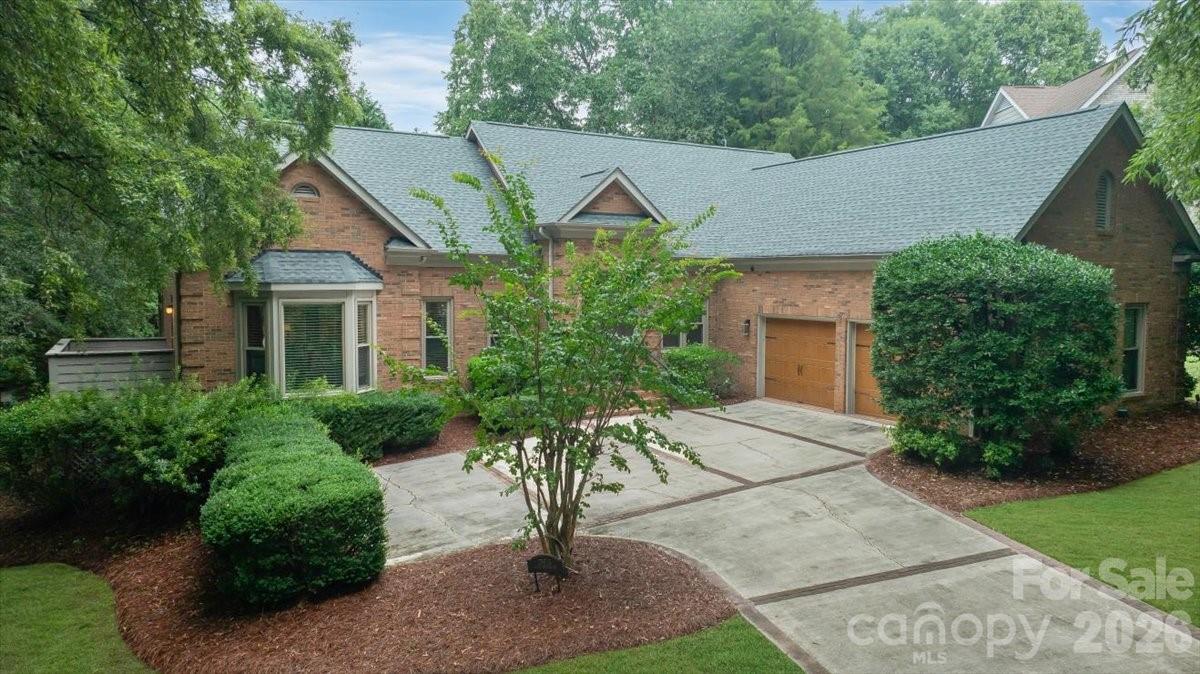 Set on nearly half an acre in Riverpointe, this full-brick, 3-bed, 2-bath ranch offers 2,669 sq ft of thoughtfully designed living space with a welcoming sense of openness throughout. Natural light moves easily through the connected living, dining, and great room areas, where architectural details and a fireplace create an inviting setting for both everyday comfort and entertaining. The updated kitchen serves as the heart of the home with generous workspace, an island, stainless appliances, and a bright breakfast area overlooking the backyard. The spacious primary suite provides a private retreat with hardwood flooring, a tray ceiling, an expansive dressing area, a well-organized walk-in closet, and a spa-inspired bath. Outdoor living continues across the screened porch, patio, and low-maintenance astroturf backyard, creating an appealing space to relax or gather. Practical updates include windows replaced approximately five years ago, a roof installed about three years ago, a newer water heater, and two AC units replaced only one year ago; the two furnaces are approximately ten years old. A 220V line in the garage adds convenient EV-charging capability. Situated within a Lake Wylie community offering lake access, a pool, tennis, walking trails, and additional recreational amenities, this home combines comfort, convenience, and an active lifestyle.