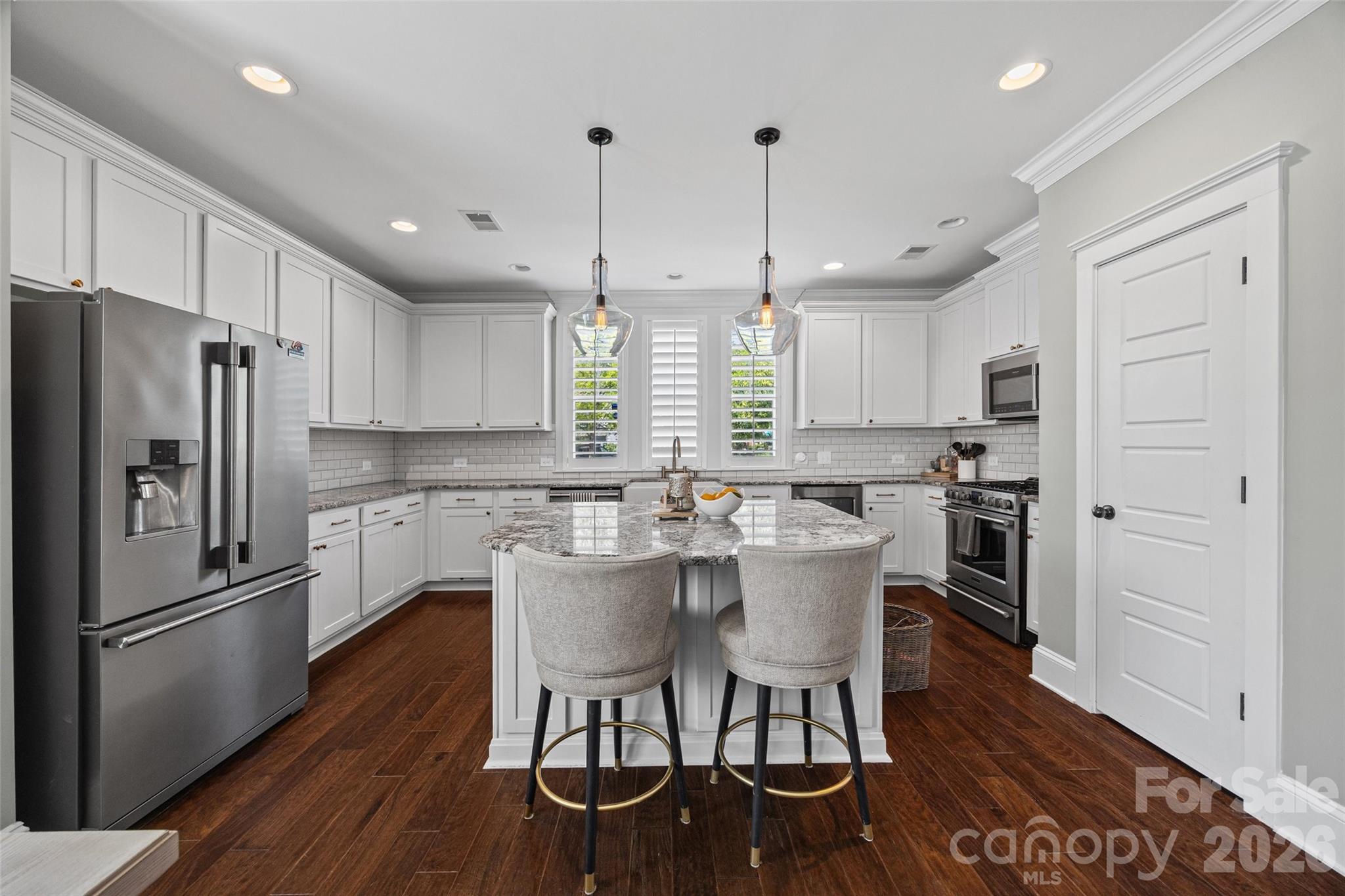 Perfectly positioned on a corner lot at the end of a quiet street, directly across from the neighborhood dog park, this beautifully maintained home offers both comfort and convenience in an unbeatable location. With easy access to I-85, commuting to Charlotte is effortless, while the charm, dining, and local shops of downtown Belmont are just minutes away.

The main level features a bright, open-concept layout designed for everyday living and entertaining, with seamless flow between the kitchen, dining, and living spaces. You’ll love the updated kitchen, complete with stainless steel appliances, granite countertops, tile backsplash, farmhouse sink, and a spacious pantry. Step outside to the side patio and fenced yard—perfect for relaxing or hosting.

Recent updates include fresh paint, and beautifully updated bathrooms, giving the home a clean, modern feel. The spacious primary suite offers a comfortable retreat with hardwood floors, a sitting or workspace area, and a well-appointed en-suite bath featuring dual vanities, a large tiled walk-in shower, and a generous closet.

Additional upgrades include plantation shutters, crown molding, custom lighting, a drop zone at the garage entry, built-in beverage fridge, and a thoughtfully designed laundry room with cabinetry and a built-in ironing board. Outdoor features a hardscape patio with lighting, and a fenced yard.

The community itself is a standout, offering a welcoming atmosphere with amenities such as a pool, clubhouse, playground, green spaces, and a dog park—making it easy to enjoy both neighborhood living and an active lifestyle.