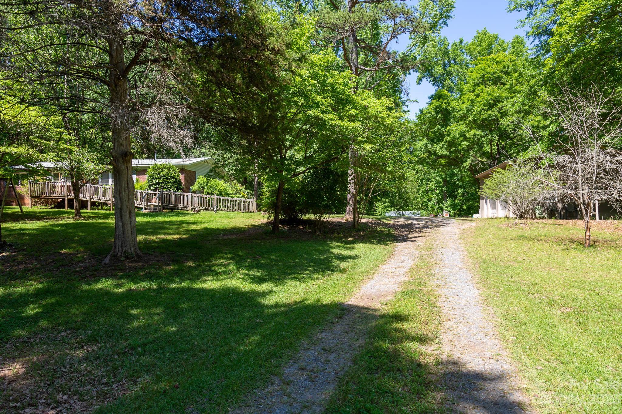 5.2 acres, NO HOA! RARE Opportunity in Fort Mill!  This charming 3 bed, 1 bath one level home has so much potential.  With 5.2 acres, you'll have plenty of space to create your own private paradise. Hard wood floors in all 3 bedrooms and living room. 24x30 workshop/garage has water & electric.  Located in a highly sought after Fort Mill School District, this property is the perfect opportunity and hard to come by in this area.