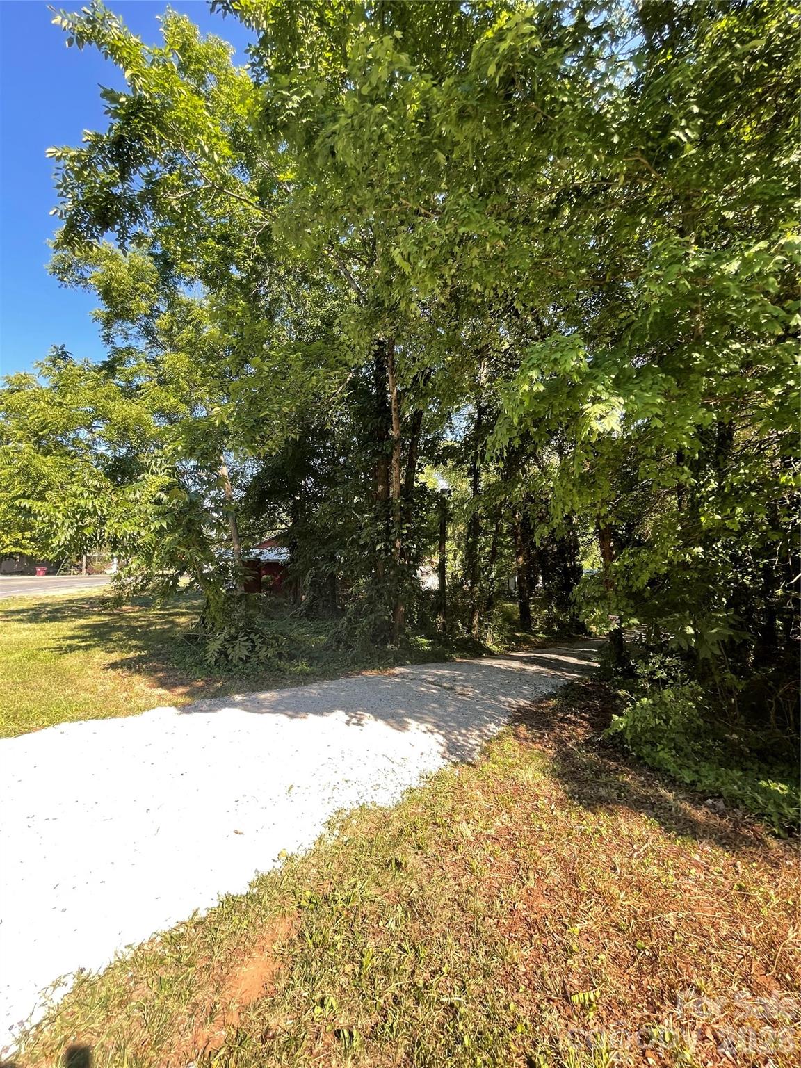 Own 1.65 acres of versatile mechanical and workspace paradise for just $179,777 at 2507 Long Ferry Rd, Salisbury, NC. This expansive property offers an unmatched setup for automotive enthusiasts, collectors, or hobbyists. City water is available at the property, with no septic or sewer currently installed. For work and storage potential, the ultimate mechanical garage features a massive 20'x90' footprint fully climate-controlled by a 2.5-ton heating and A/C system, complete with a professional-grade 10,000-pound two-post vehicle lift. The property includes three total buildings, featuring two separate 20'x90' structures that offer massive square footage for workshops, collector storage, or hobby operations. Outside, a dedicated 40'x90' parking area easily accommodates personal fleet vehicles, boats, or RVs, while a wide, U-shaped driveway provides effortless pull-through access for large trucks, trailers, and campers without the need for tight turnarounds. Additional highlights include a detached 500-square-foot climate-controlled flex building equipped with its own heating and cooling mini-split, perfect for a deluxe pet facility or specialized storage. The 1.65-acre grounds are enhanced by a great, easily accessible location and 10 mature fruit trees offering fresh, seasonal harvests of apples, pears, peaches, and figs.
