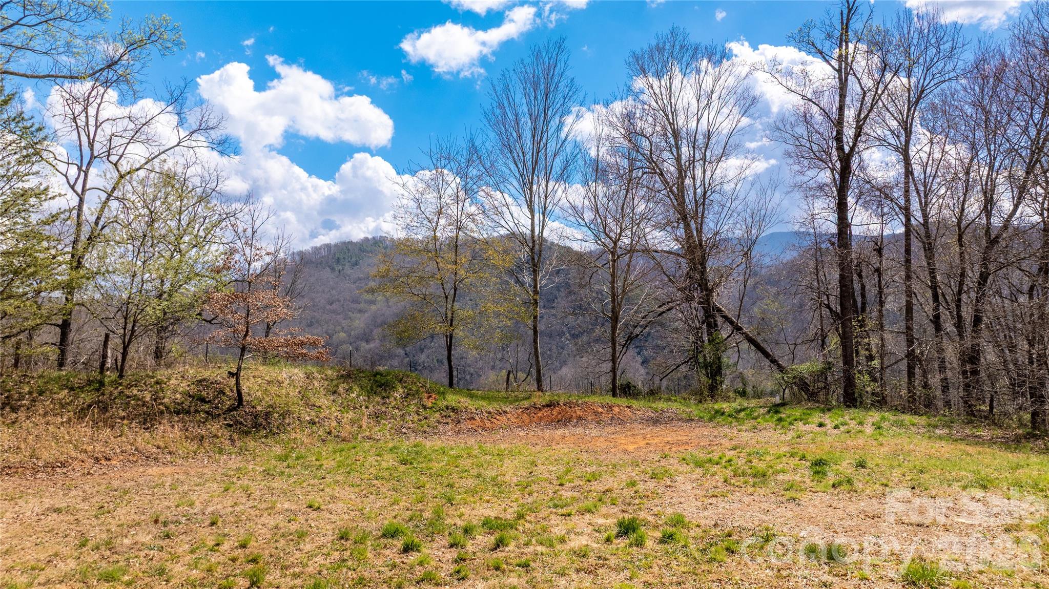 This hard-to-find homesite in the scenic Cruso area—90 Last Coyote Trail offers a rare combination of privacy, usability, and convenience on 0.75 acres. Much of the groundwork has already been completed, including a private well, 3-bedroom septic system, electricity, driveway, and a prepared building site, making it easy to move forward with your plans.

The lot features a tiered layout that has been cleared and positioned to take advantage of mountain and pastoral views from the rear of the property. With only a handful of homes nearby, this setting provides a quiet, low-density environment while still offering easy access to Cruso Road. A 1,300 square foot minimum build requirement is in place.

Located just minutes from Canton and Waynesville, and a short drive to I-40, the property also places you close to some of Western North Carolina’s best outdoor destinations—Pisgah National Forest, the Blue Ridge Parkway, Pigeon River, and numerous hiking and waterfall areas.

Whether you’re planning a full-time residence or a mountain getaway, this lot offers a strong head start with key improvements already in place and a location that balances seclusion with accessibility.
