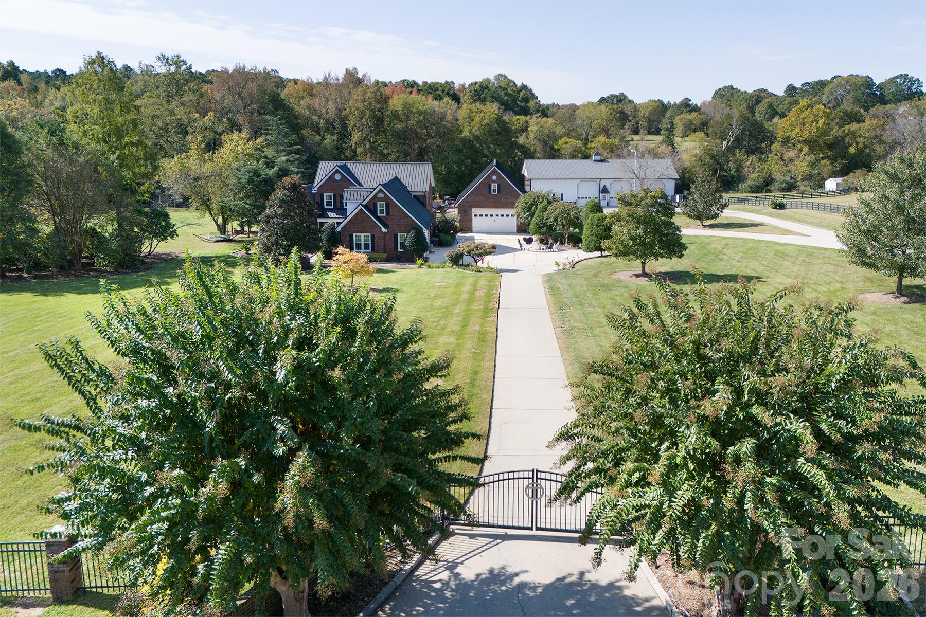 Set on a 5.81acres of beautifully maintained lawn and landscape, this exceptional property offers the perfect blend of privacy, comfort, and high-end upgrades—your own suburban retreat. The full brick exterior delivers timeless curb appeal and low maintenance, complemented by major improvements including a commercial-grade 50-year metal roof, new HVAC systems and ductwork, tankless water heater, upgraded windows, and a fully encapsulated crawlspace.
Inside, an open and inviting floor plan centers around a chef’s kitchen, spacious great room, and a light-filled sunroom with custom built-ins—ideal for everyday living and entertaining. The primary suite is a true escape, featuring a spa-like bath and a generous walk-in closet with custom shelving.
Step outside to a private backyard oasis complete with a 20,000-gallon saltwater pool, Coolcrete decking, outdoor fireplace, gas grill, and refrigerator—perfect for relaxing or hosting gatherings. The property is fully fenced and gated, with smart home technology providing added convenience, security, and peace of mind.
A versatile 40x80 shop with 220-amp power and a heated/cooled office offers endless possibilities for hobbies, storage, or workspace.
With acceptable offer, the seller will consider including pool furniture, umbrellas, planters, zero-turn mower, and various home furnishings, making this a truly turnkey opportunity. Don’t miss your chance to own this one-of-a-kind retreat!