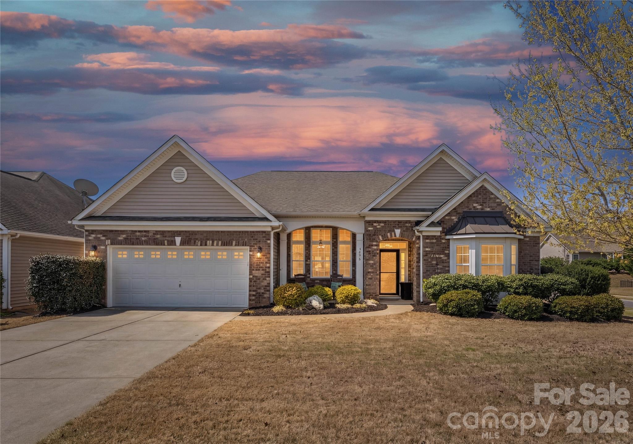 Experience elevated one-level living in the highly sought-after Lake Ridge community of Tega Cay SC—just minutes from Baxter Village, Kingsley, and a short 30-minute drive to Charlotte Douglas International Airport. Situated on a desirable corner lot with added privacy from mature trees, this beautifully maintained ranch-style home offers the perfect blend of comfort, convenience, and lifestyle.

Spanning approximately 2,477 square feet, this thoughtfully designed home features 3 bedrooms, 2 full bathrooms, a dedicated office, and a formal dining room—ideal for both everyday living and entertaining. The open layout is enhanced by wood and LVP flooring throughout, creating a seamless and low-maintenance living experience.
The inviting living room is upgraded with a Heatilator fireplace with fan, LED recessed lighting with dimmer, and a remote-control ceiling fan—creating a warm and modern atmosphere. A Nest thermostat (2025) adds smart home convenience. 

The light-filled sunroom, complete with a remote-control fan, offers a peaceful retreat, while the kitchen is equipped with under-cabinet LED lighting, a solar tube for added natural light, and a full suite of appliances including a Whirlpool refrigerator, newer dishwasher (2025), Frigidaire range (2024), GE microwave, and InSinkerator disposal.

The spacious primary suite features a walk-in closet and a beautifully updated bathroom with Taj Mahal quartzite countertops, updated sinks, faucets, lighting, new flooring, a soaking tub, and a walk-in shower—creating a spa-like experience.

Step outside to an expansive stamped concrete patio (26’ x 16.5’) designed for true indoor-outdoor living. Enjoy a Phantom retractable screen door, a motorized awning with wind sensor, and professionally installed landscape lighting on a timer—perfect for relaxing evenings or entertaining guests.

Additional upgrades include updated LED lighting throughout key areas of the home, a garage with MyQ smart opener and keypad access, and all smoke and CO detectors replaced in 2022.

Major system updates include a Trane XR heat pump and air handler (2025) with a transferable 10-year warranty (14.8 SEER), offering peace of mind and energy efficiency.

Residents of Lake Ridge enjoy resort-style amenities including an Olympic-sized outdoor pool, tennis courts, basketball courts, and scenic walking trails. Located within the top-rated Fort Mill School District (Kings Town Elementary, Gold Hill Elementary, and Fort Mill High School).

Ideally located near Nivens Creek Landing, where you can launch your canoe, kayak, jet ski, or your boat and enjoy direct access to the water-bringing a true lake lifestyle. Also close to Baxter Village, Kingsley, Tega Cay Golf Club, parks, and walking trails. Approximately 25 minutes to Ballantyne, and 30 minutes to Charlotte Douglas International Airport.

Ideal for downsizers or buyers seeking low-maintenance, single-level living in a premier Fort Mill location.
