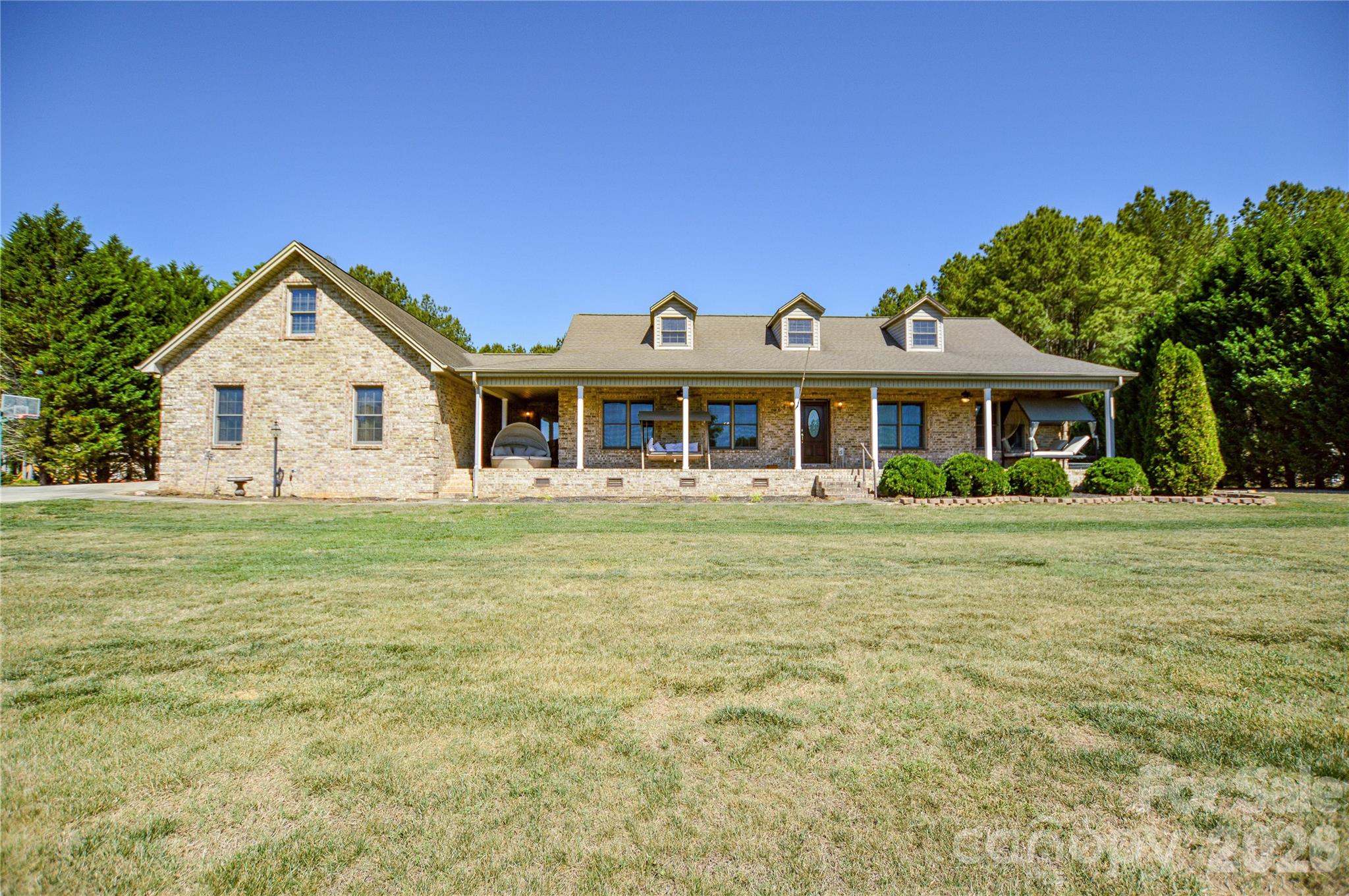 Nestled on approximately 2 private acres in the peaceful countryside of Taylorsville, this beautifully maintained 3-bedroom, 2.5-bath home offers the perfect blend of comfort, space, and scenery. Recent updates include fresh interior paint and a newly replaced rear exterior door off the dining area, making this home move-in ready.

The property features an oversized driveway, impressive 4-car garage, multiple exterior access doors, and expansive front and back porches ideal for relaxing or entertaining. Two fenced areas—one surrounding the homesite and another extending behind the tree line—provide endless possibilities for pets, gardening, recreation, or hobby farming.

Enjoy the convenience of city water while also having a well already in place that can easily be switched over if desired. An irrigation system is installed (seller has no information). Located just minutes from Lake Hickory and The Sandbar Restaurant, this home offers peaceful country living with stunning lake views while remaining close to dining, recreation, and everyday conveniences.