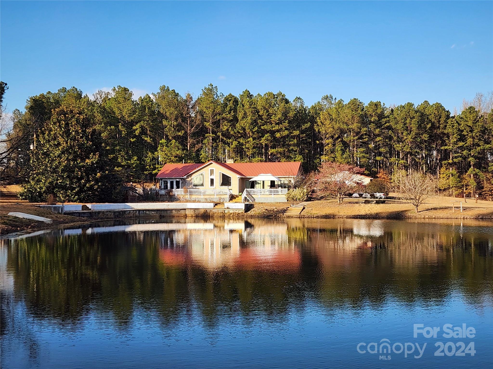 67 +/- acres of beautiful timberland with over 4100 feet of development road frontage and a secluded mid property 2 BR/ 2 BA home nestled beside a private 1 +/- acre spring fed pond. Step out of your front door and sip a beverage beside your own pond while watching the ducks float by or cast a lure to catch some fish. 40+/- acres of valuable mature planted pines are ready for a final thinning/harvest with mixed hardwoods along the creek. A detached garage has a 260 +/- sq. ft. finished bonus room, workshop, garage parking and a 50 amp RV hookup. There is fenced pasture for equestrian or livestock enthusiasts, 6 acres of electric dog fencing and existing trails in the woods for birding or deer & turkey hunting. This outdoor paradise with a small VA assumable loan is minutes from 47,000+ acres of the Sandhills National Wildlife Refuge, 2.5 hours from Myrtle Beach, 1+/- hour from Florence/I-95 & 75+/- minutes to Charlotte or Columbia. This property is truly a Sportsman's Outdoor Paradise.