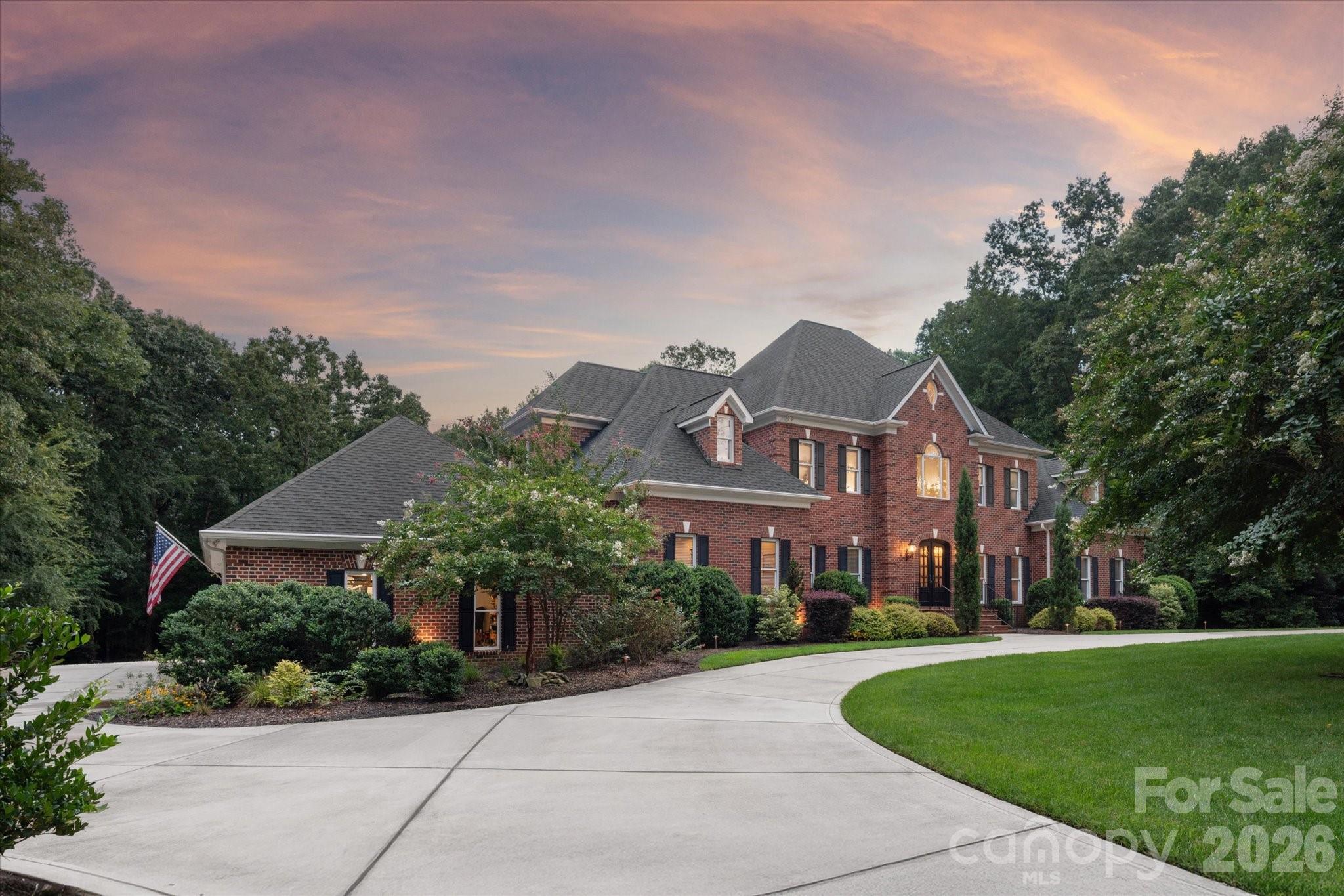 Welcome to your private retreat - a stunning luxury estate on over 2 acres and surrounded by undisturbed nature.   Offering nearly 8,000 square feet of refined living space this home is in prestigious, gated Sedgefield. 
From the moment you arrive, the circular driveway, manicured lawn, and stately curb appeal set the tone. The main level spans over 3,500 square feet, flowing effortlessly onto the screened porch and outdoor entertaining areas - perfect for large gatherings, sporting events, or quiet relaxation. Originally built in 2000 and fully remodeled in 2018, this home now includes a show-stopping oversized heated saltwater pool and a kitchen that is every chef's dream. Gourmet kitchen with commercial-grade appliances, large scullery, and endless natural light!  Primary Suite on main level and upper level - both with spa baths and custom closets.  Upstairs includes 2 additional bedrooms with ensuites and a spacious loft.  3rd floor is a private bedroom with full bath.  Basement level offers pool bath, recreational spaces and endless storage. 4-car oversized garage is constructed for lifts — ideal for the car collector! This home was built for both entertaining and everyday luxury. Whether you're relaxing poolside, hosting a crowd, or enjoying a quiet evening at home, every square inch of this estate reflects quality and thoughtful design.  Top rated Marvin Ridge Schools!