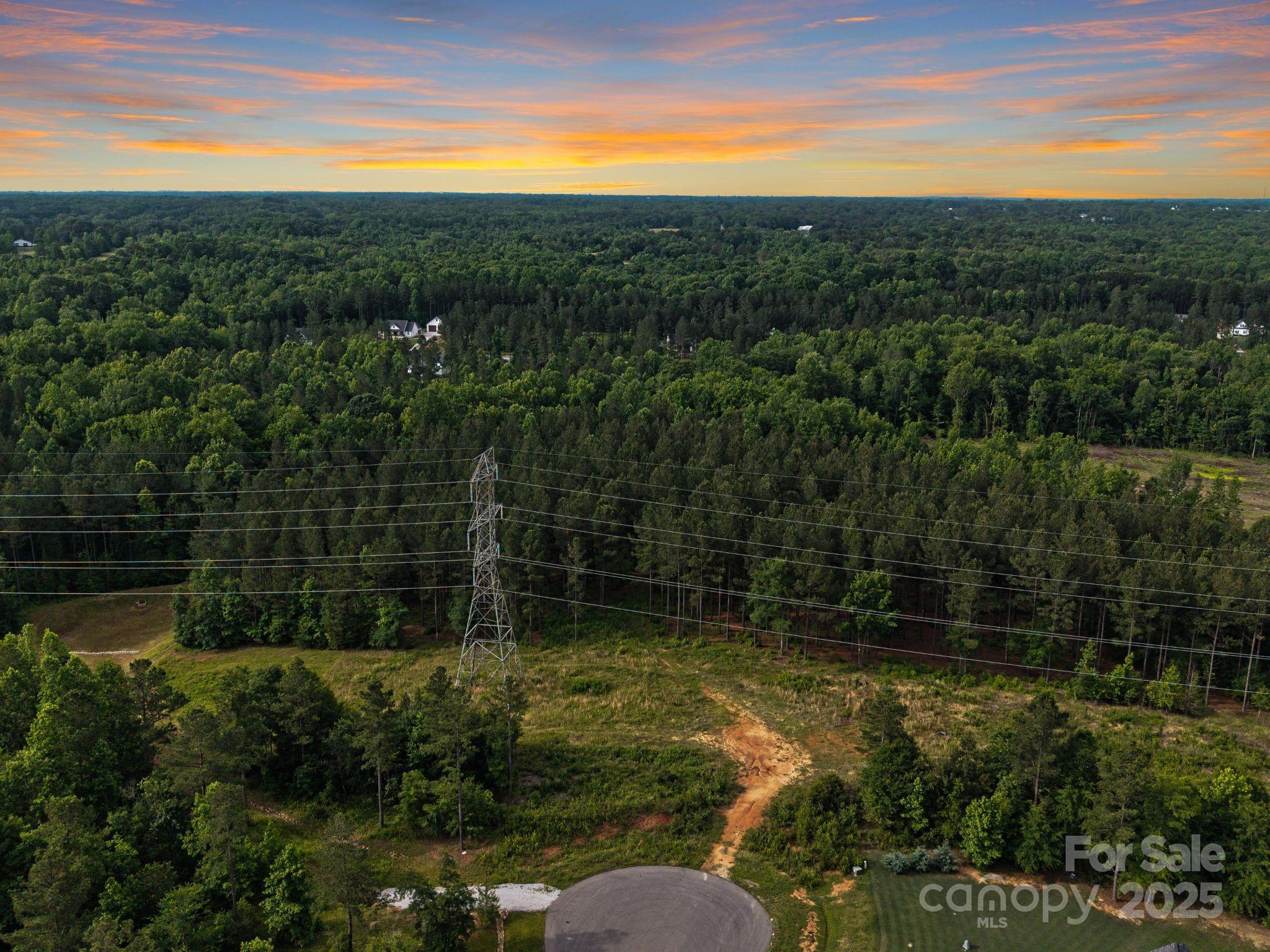 Tucked at the end of a quiet cul-de-sac in the picturesque Sanders Landing community lies a hidden gem — 6.2 acres of possibility. Imagine waking up surrounded by the whisper of mature trees and the gentle flow of Morris Branch Stream along your property’s edge. This rare homesite offers the kind of peace and privacy that feels worlds away, yet it’s just minutes from the small-town charm of downtown Clover — with its local shops, dining, and weekend events. Sanders Landing is known for its estate-sized lots and timeless character, designed to preserve the area’s natural beauty while giving homeowners space to build something truly special. With room to dream big and design a home that’s uniquely yours, this property is perfect for those who crave serenity without sacrificing convenience. Site-built homes only, with well and septic needed. Reach out today for details, builder recommendations, or to take a peaceful walk of the land where your future could take root.
