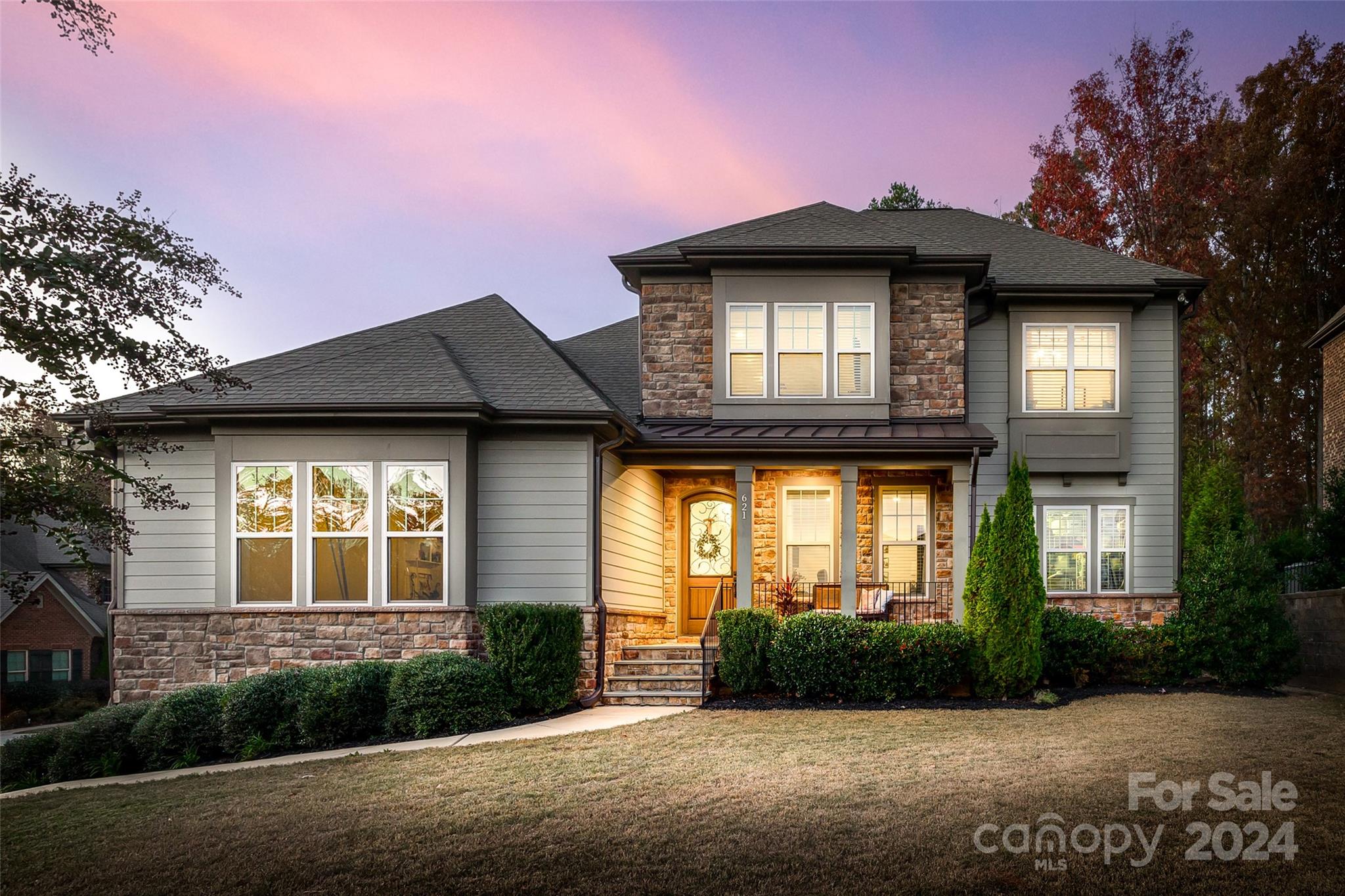 Nestled in a wooded backdrop in the sought after community of Eppington South, this stunning home will leave you nothing short of impressed! A relaxing front porch greets you as you make your way in on gleaming wood floors that run throughout the downstairs, & upfront a study w/ french doors. The showstopper great room is grounded by a stacked stone fireplace flanked by built-ins, & has tons of natural light. The chef's kitchen boasts an expansive island, gas cooktop w/ SS hood, double ovens, SS apron sink, cabinets to the ceiling, a pot filler, & more! The primary on main highlights views of the treed lot, & the massive bath has dual quartz vanities, soaking tub & walk in tiled shower, & a generous closet. Upstairs you'll find a large loft, as well as 3 bedrooms and 2 bathrooms (1 bath is ensuite). The backyard has a large covered back porch that pours onto a flagstone fire pit area and fenced yard with tons of privacy. W/ low SC taxes & easy access to shopping & I77, welcome home!