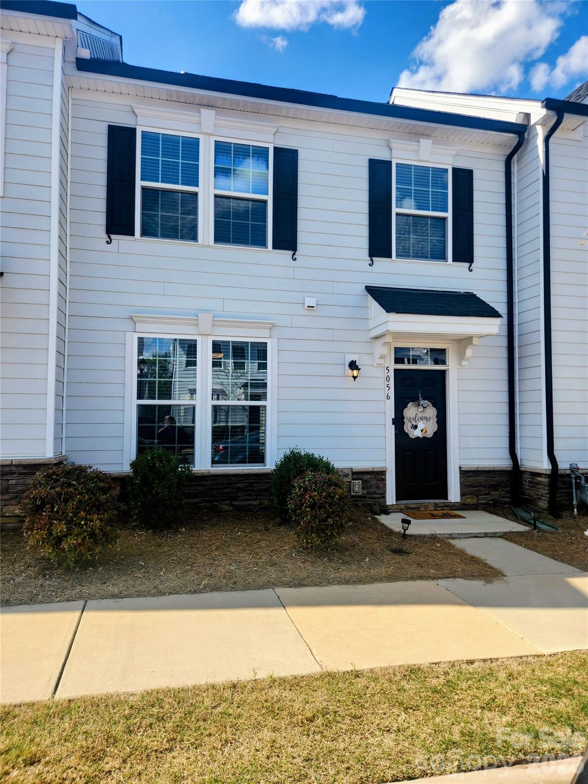 This modern farmhouse-style townhome built in 2020, offering low-maintenance living with high-end upgrades throughout. This 3-bedroom, 2.5-bath home features a private courtyard with a lawn, privacy fencing, patio pad, and gas line for grilling. The 2-car garage is located in the rear, with additional street parking in front. Inside, enjoy an open floor plan with abundant natural light, large open plan kitchen to dining and living rooms. Upstairs, the spacious primary suite includes a walk-in closet and en-suite bathroom. Laundry is conveniently located upstairs with additional storage space. Two more generously sized bedrooms and a full bath completes the upper level. Other features include 9' ceilings on both floors, smart home features, and a tankless water heater. All appliances stay! Move-in ready!