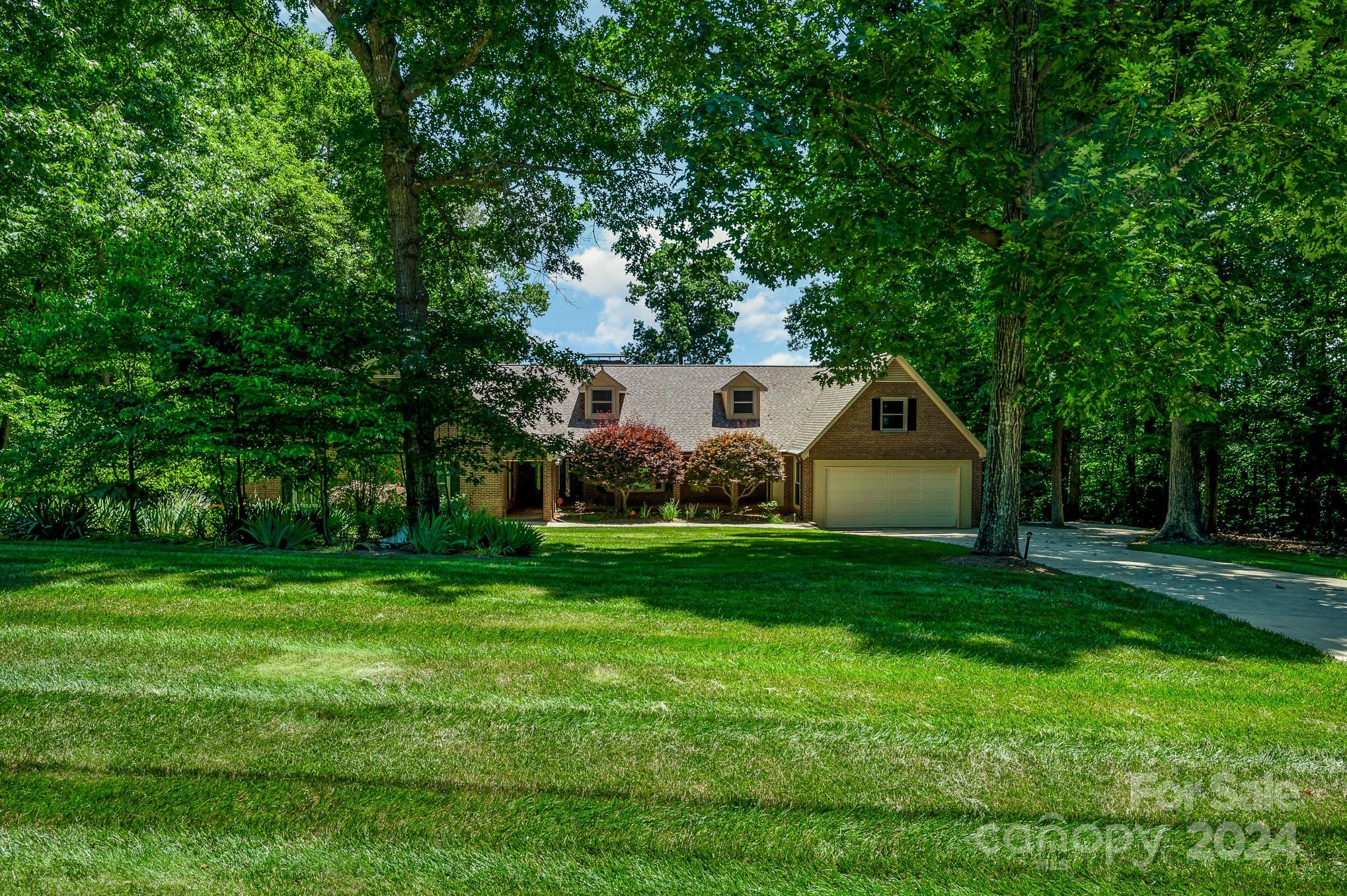 While the term “One-of-a-Kind” is overused, this is a genuinely unique property! Start in the back with 150’ of lake shoreline, dock, seawall & stairs for easy water access; Stroll across the open yard full of mature trees & landscaping to the custom built home; This floor plan has something for everyone -- HUGE kitchen, open great room w/wood burning fireplace, bright sunroom w/gorgeous views, primary suite w/French doors leading to a screen porch that stretches 62’ across the back, oversize secondary BR’s, large laundry/mud room, open loft w/sitting area, bonus/2nd primary w/full bath & gas fireplace, AND a basement perfect for just about anything; Need storage? Unfinished area in the basement has double exterior doors, enclosed room in the garage, & two enclosed storage areas accessible from the covered patio; Low-E energy efficient windows, heat reducing radiant barrier in the attic, water filter/softener system, termite bond, & two water heaters; Must see to appreciate everything