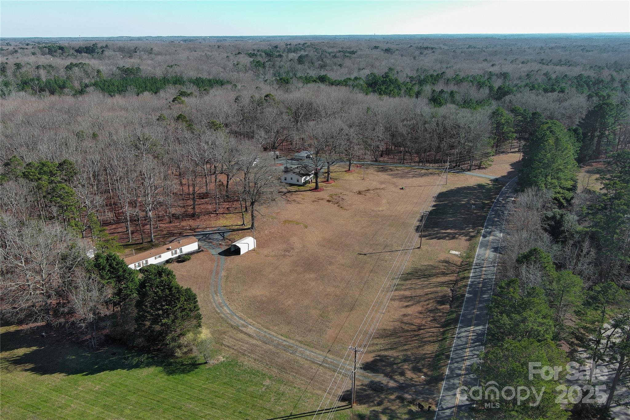 What an incredible FIND in Weddington.  An unbelievable opportunity to acquire 16.66 acres of undeveloped land. Original homeplace and mobile home still on the property(both of no value).  The value is in the land.  Wonderful parcel of land for your dream home or family estate.  Excellent potential for a residential community.  Gorgeous 100 year old oak trees that shade a portion of the serene property.
The land is about half cleared and half trees. There is county water already on the property but also a private well that could be used for the lawn , garden or animals.
This generous parcel of land offers rural living with the convenients of urban amenities.  Minutes from downtown 
Matthews, Waxhaw and 485 interstate.
