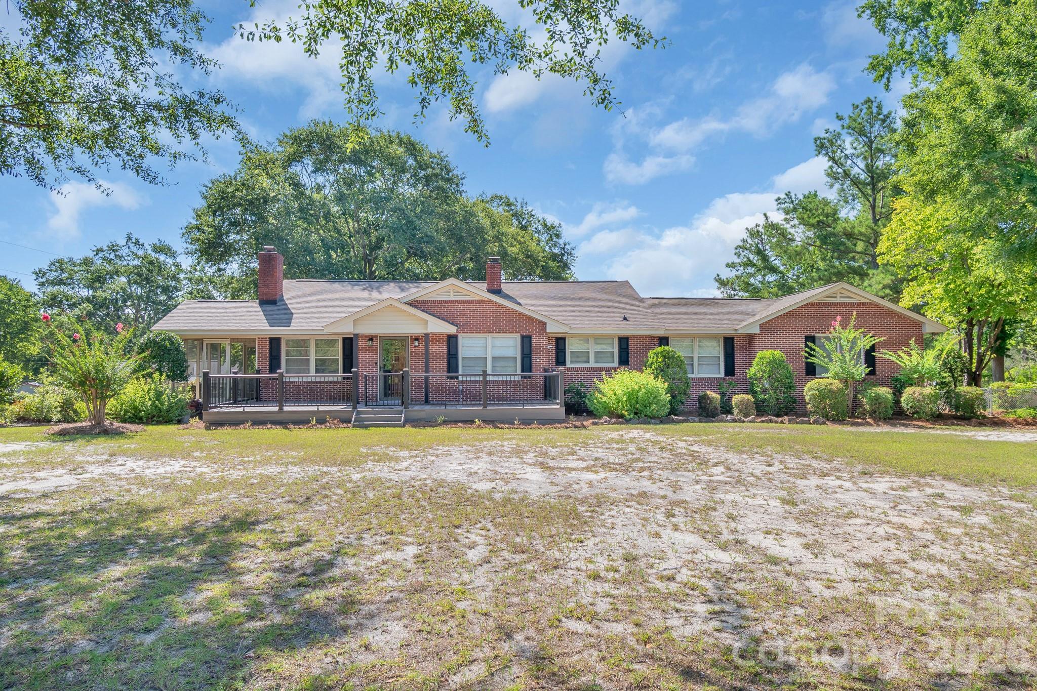 WELCOME HOME TO 'PARK DRIVE'! A beautiful spacious 2172 sq ft brick home that leads to the popular KERSHAW COUNTRY CLUB & GOLF COURSE. Mostly original hardwoods throughout, the home has 3-4 bedrooms, 2 baths w/ the possibility of 3 baths.  All appliances convey w/ a brand new hot water heater recently installed. In the ('could be master bedr.), a remote gas log FP, w/ a (could be) walk in closet, 2 doors leading out to a private porch overlooking the pool & a 30X24 shop/mancave!  A beautiful shrubbery-appointed backyard w/ a playhouse.  Also, another storage shed...can't have too many! This home 'glows' w/ warmth & love. Be the FIRST to see this beautiful home in a 'prime' location.  
A FEW OTHER PERKS: A NEW POOL LINER TO BE INSTALLED, 30 AMP PLUG FOR CAMPER, TOUCH FREE KITCHEN FAUCET, GAS LOGS W/ REMOTES, NEW SHUTTERS, ALL APPLIANCES CONVEY, JACUZZI TUB. .553 ACRE LOT W/ 121.3 FT OF RD FRONTAGE!