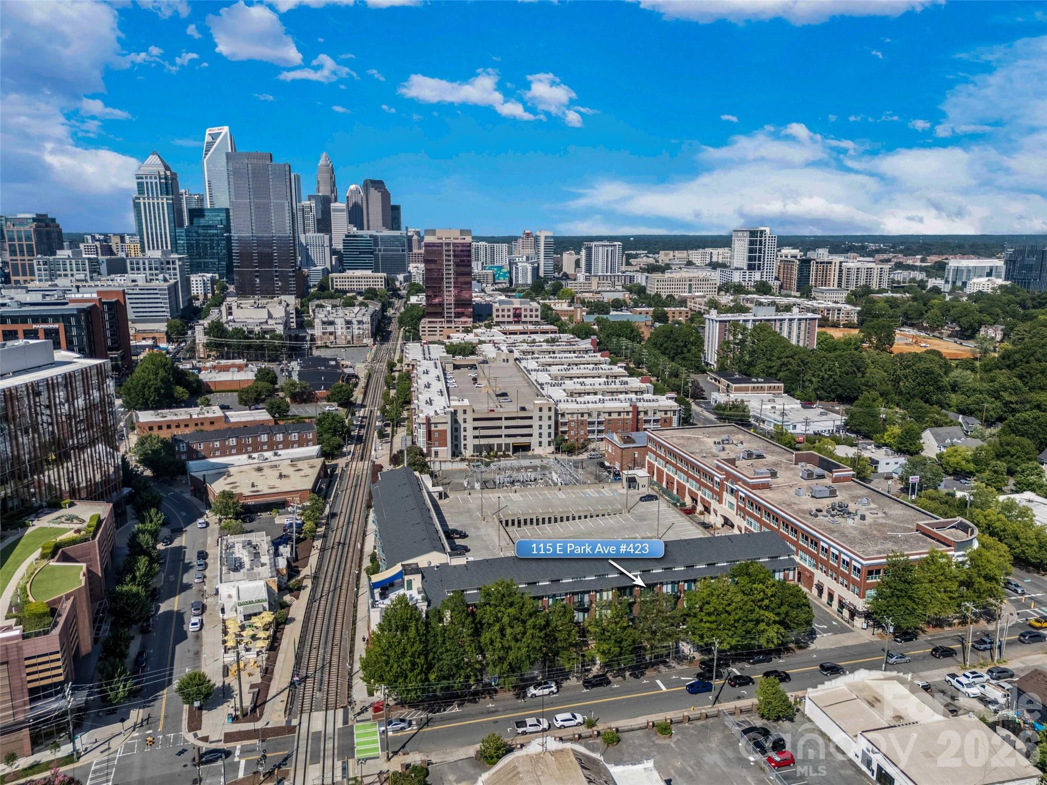 The ULTIMATE South End location! Just steps from the Rail Trail and some of Charlotte’s most popular restaurants and nightlife, this top-floor 1-bedroom, 1-bath condo offers the perfect blend of convenience and privacy.  Located on the 4th floor with easy access from the parking garage, this freshly updated unit features soaring ceilings and dramatic floor-to-ceiling windows that flood the space with natural light. The open-concept living area flows seamlessly into the kitchen, complete with wood cabinetry, stainless steel appliances, and a breakfast bar with stone countertops.  Enjoy your morning coffee or unwind in the evening on the private balcony overlooking vibrant South End activity.  The main level includes a welcoming foyer with a convenient storage closet, a laundry closet with brand new GE stackable washer and dryer, and a beautifully updated full bathroom featuring tile flooring, a stone countertop, a fresh vanity, and a modern backlit LED mirror.  Upstairs, the lofted bedroom offers a spacious built-in closet system designed for maximum organization.  Residents also enjoy access to a stunning rooftop terrace with unbeatable Uptown views—perfect for entertaining, working remotely, or simply relaxing.  Freshly painted and brand new flooring throughout, this move-in ready condo is a rare opportunity in one of Charlotte’s most sought-after locations. Don’t miss your chance at this great condo to work and live!