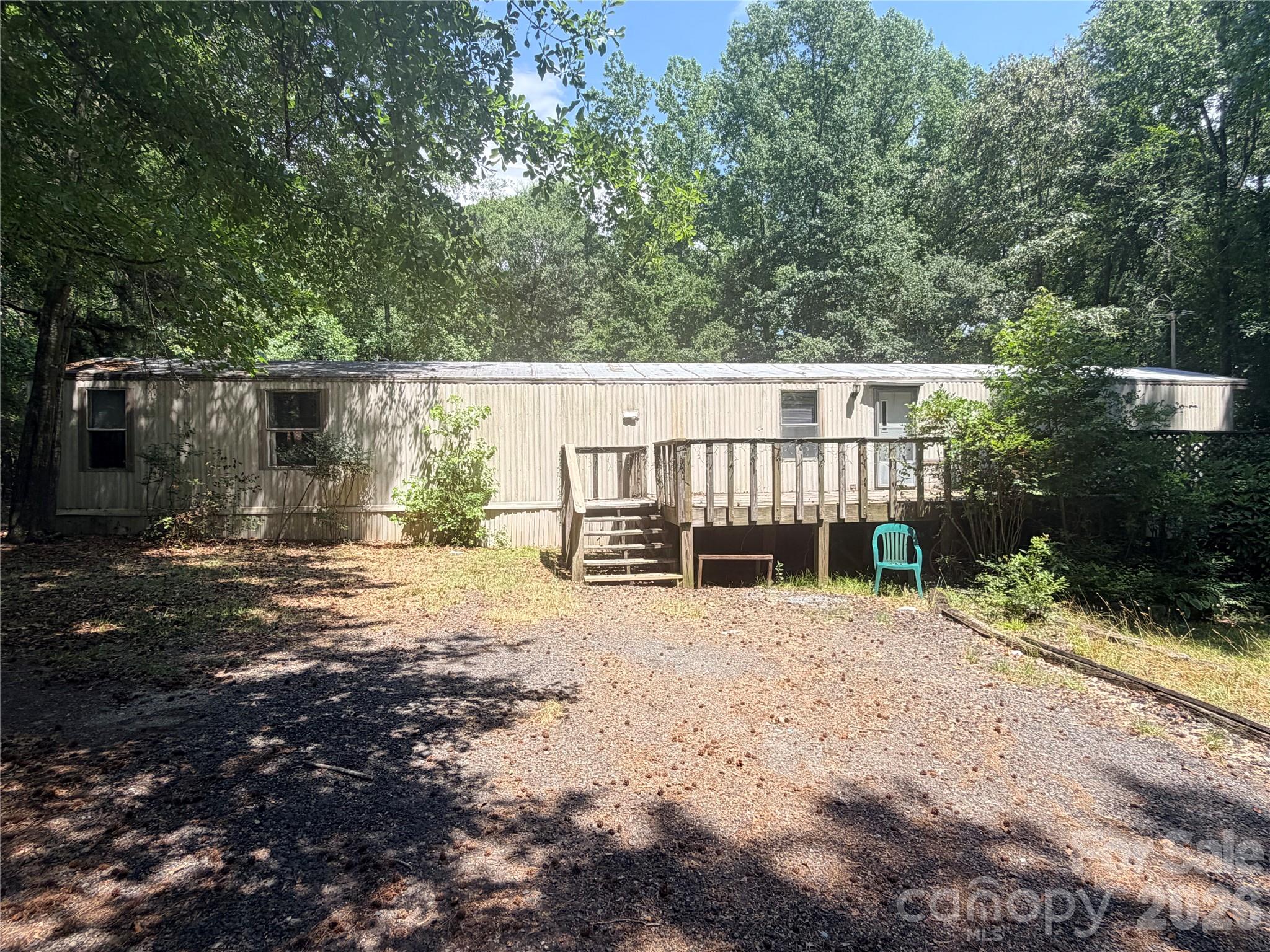 Endless Possibilities on 2.3 private, wooded acres.  Featuring a 1993 Oakwood single-wide ready for your personal touches.  Incredible exterior setup includes a large deck, two sheds and a 17 x 24 plus workshop with a wood burning stove, 1 ton manual ball bearing trolley and additional gathering space. Enjoy country living close to Rock Hill and I-77.