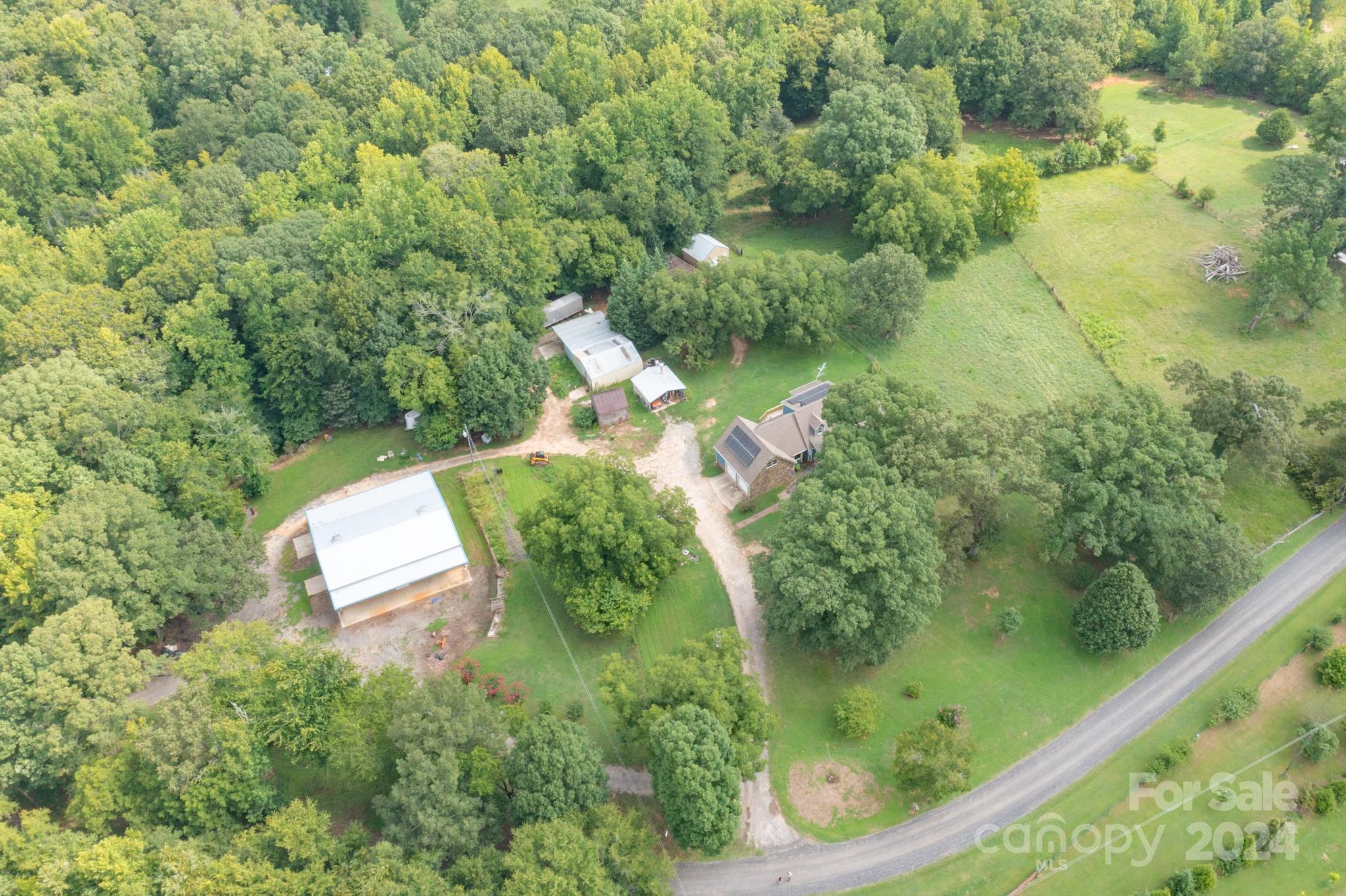 Unique Property Alert! Incredible 3 bedroom,3 full bath house, 40X60 Workshop, Motorcoach parking. 30X37  Woodworking shop, Barn and cattle Shute. Cross Sectioned gated pastures. All on 22 acres with a creek!! Large unfinished bonus room upstairs, as well as an additional walk in attic space provide incredible storage or opportunity the for additional sq ft.(heat and AC already vented) The home and shops are heated with an Outside wood furnace.  A few additional features of the house are: Solar Panels, new HVAC unit installed July 2024. 6 inch gutters, metal leaf guards, double vinyl window approximately 5 years new.  Oversized chicken coop and dog pen. Convenient Underground lines plumbed to fill water troughs.  
Bring Nature indoors with the beautiful Sunroom.  Enjoy sitting on the  newly constructed back deck while admiring the large pecan trees, wildlife and all that clean country living has to offer.  If your passion is horses, farming or gardening...Welcome home.