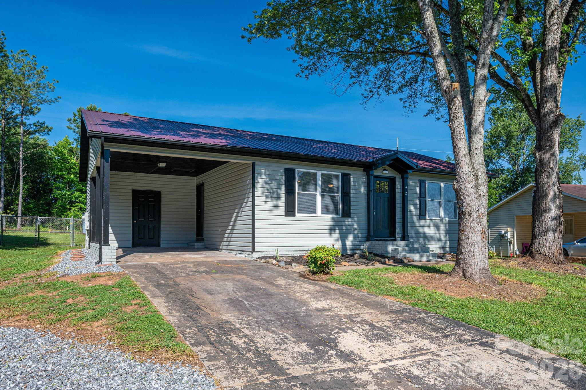 Remarkably Renovated Ranch in the Heart of Maiden!  Check out this beautifully updated 3-bedroom, 2-bath vinyl ranch located within walking distance of downtown Maiden and just blocks from local parks and the Maiden Recreation Center. Offering a blend of modern updates and small-town charm, this move-in ready home is sure to impress.  Inside, you'll find updates throughout, including a spacious kitchen and dining area featuring new cabinetry, granite countertops, stainless-steel appliances, and ample space for gatherings. Both bathrooms have been tastefully renovated, while beautiful wood and tile flooring flow throughout the home, creating a warm and inviting atmosphere.  Step outside to enjoy the rear deck overlooking the fully fenced backyard—perfect for entertaining, pets, gardening, or simply relaxing outdoors. A one-car carport provides convenient covered parking and additional storage options.  Located in the Town of Maiden and just minutes from Hwy 321, this home offers an easy commute to both the Hickory and Charlotte metro areas while allowing you to enjoy the benefits of small-town living.  Don't miss this opportunity to own a beautifully renovated home in a convenient and desirable location. Come experience all that Maiden has to offer!